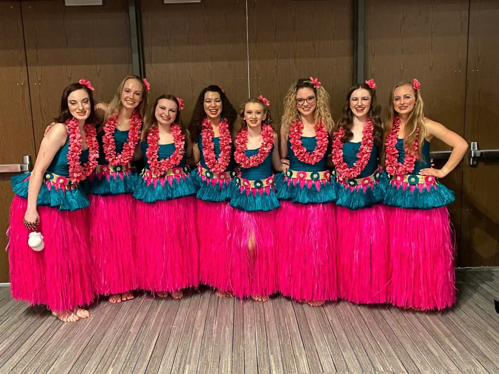 a group of women in colorful dresses