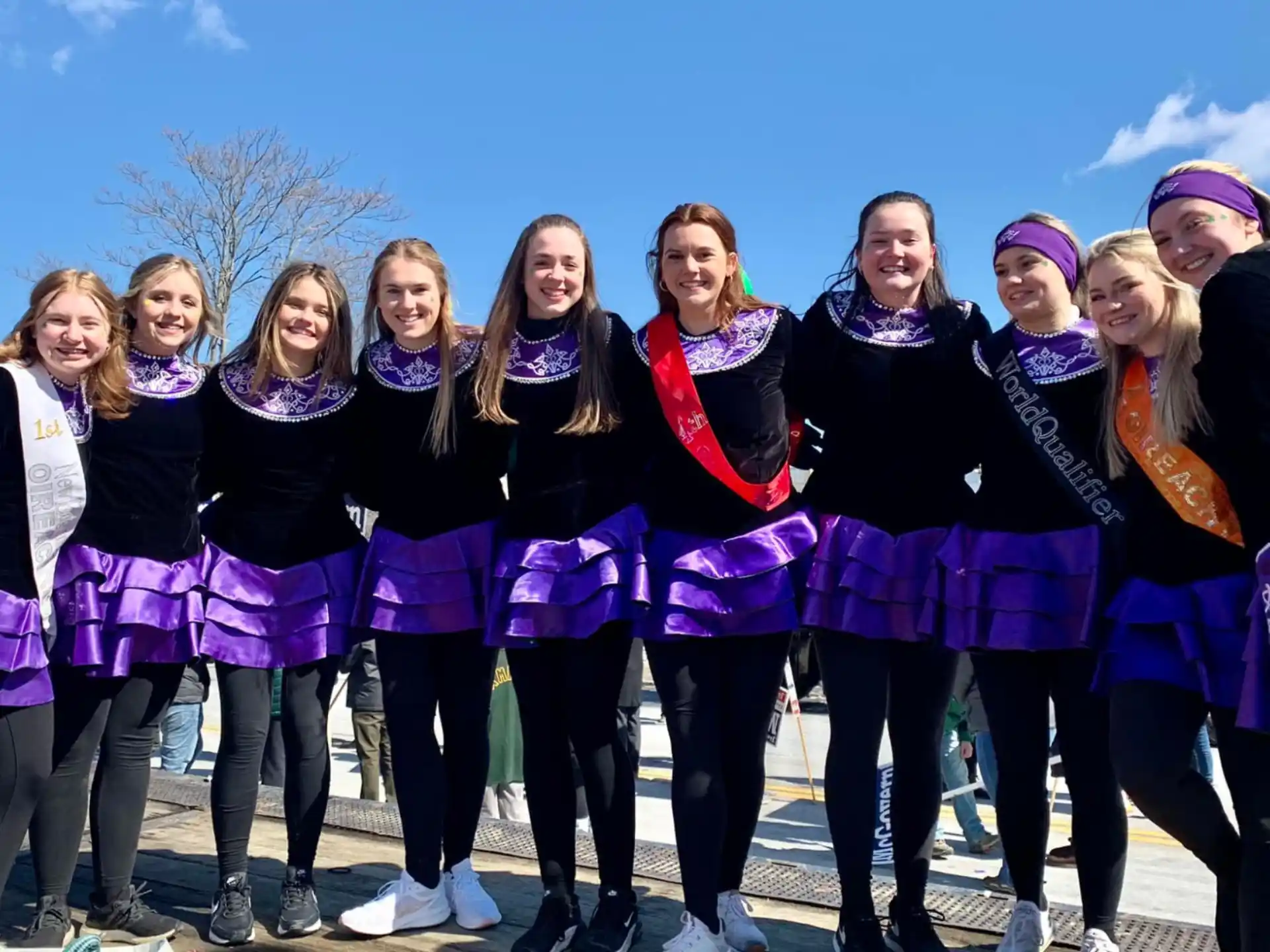 a group of women in purple and black uniforms