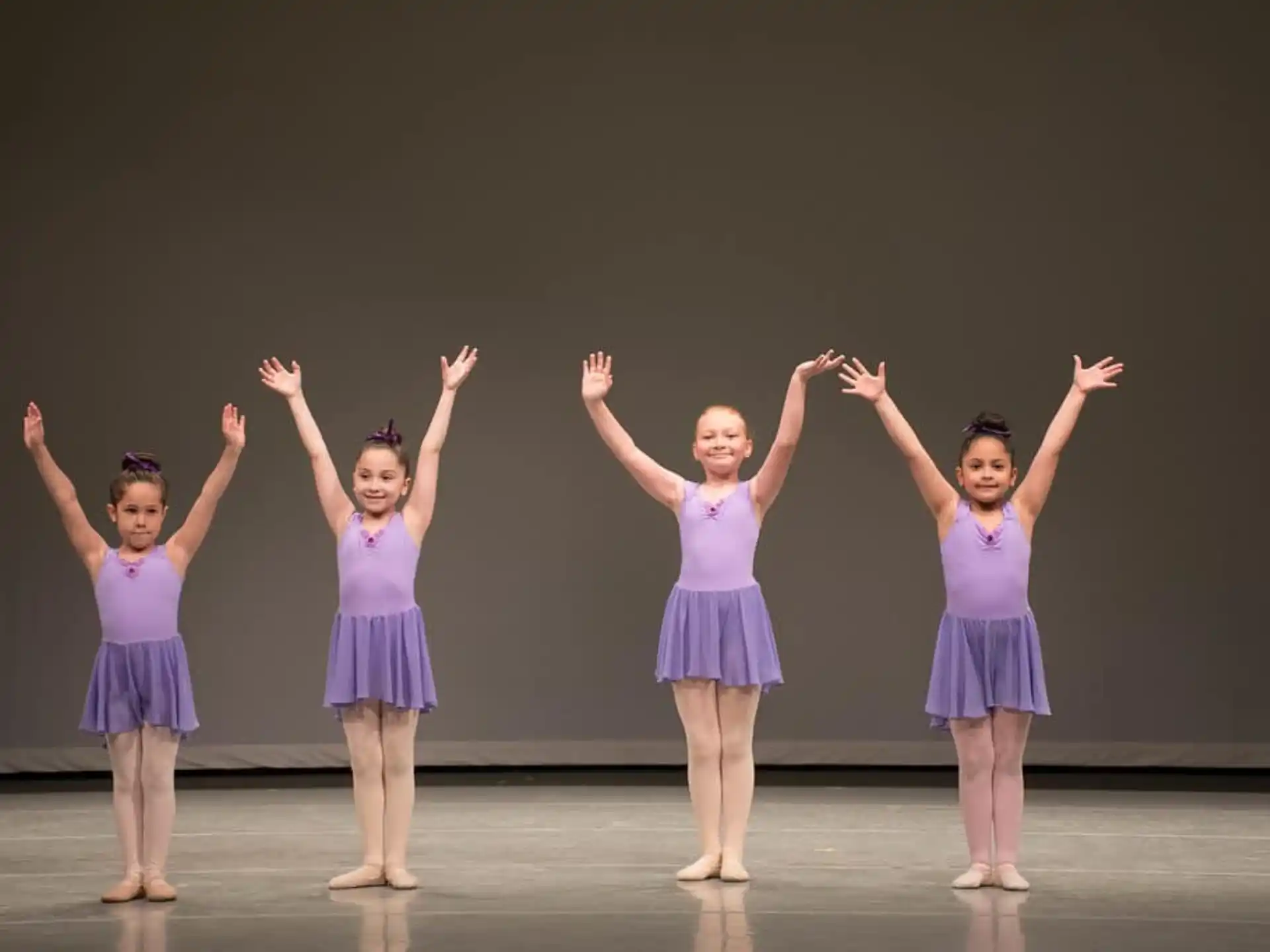 a group of girls in purple dresses