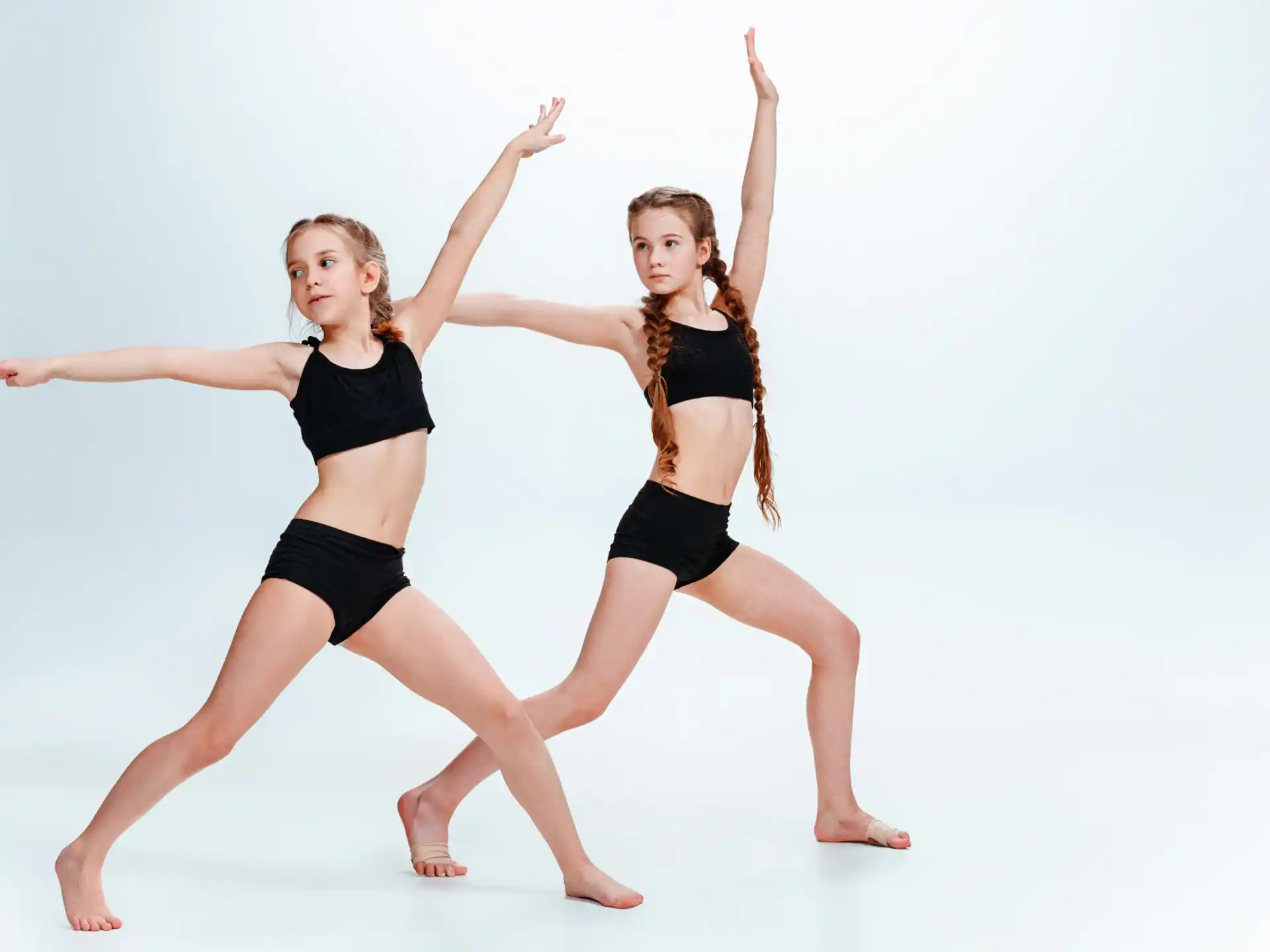 two women dancing on a white background