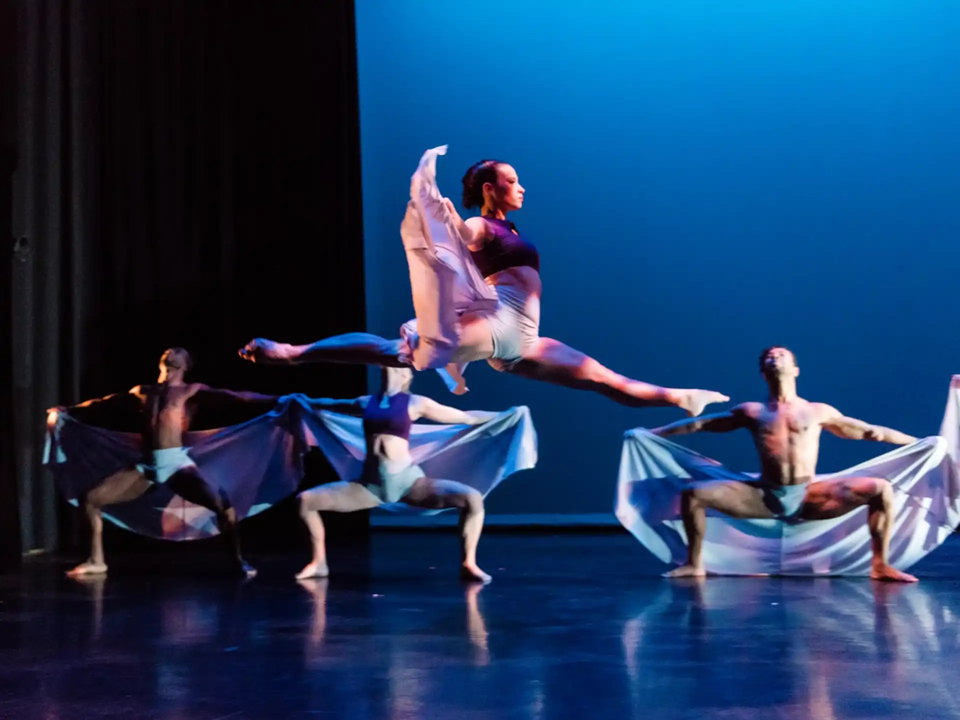 a group of people dancing on a stage
