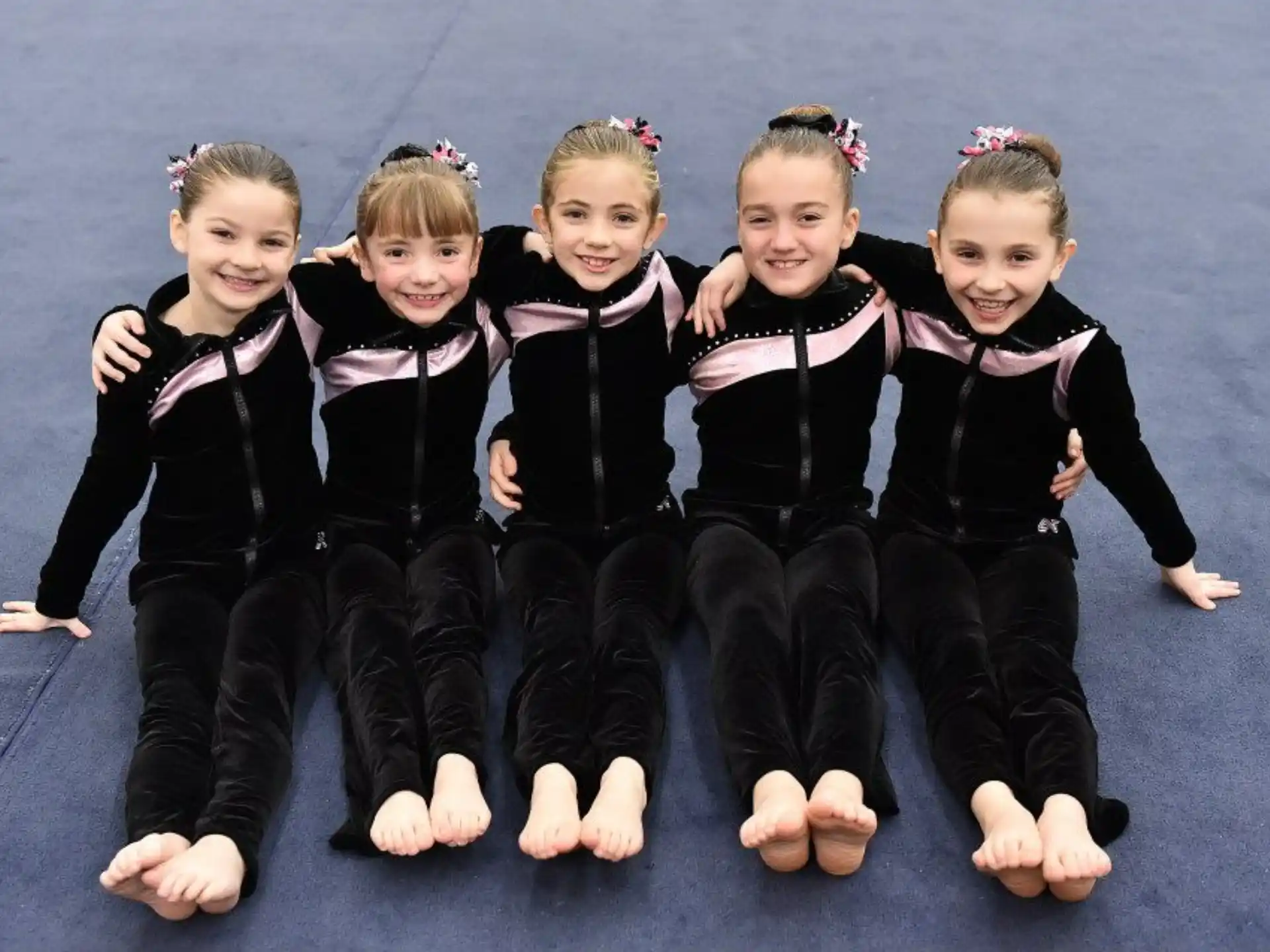a group of children in black and white uniforms