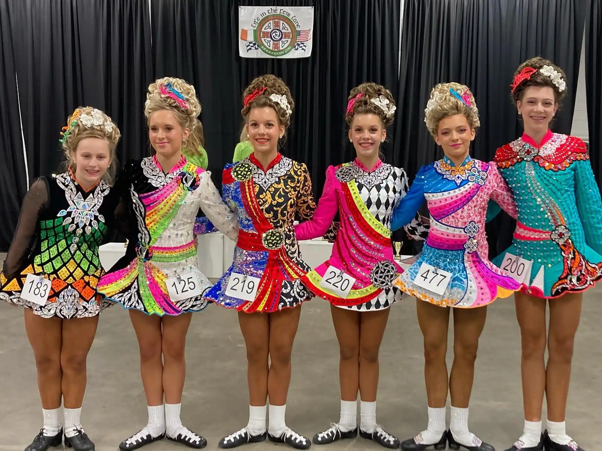 a group of women in colorful dresses