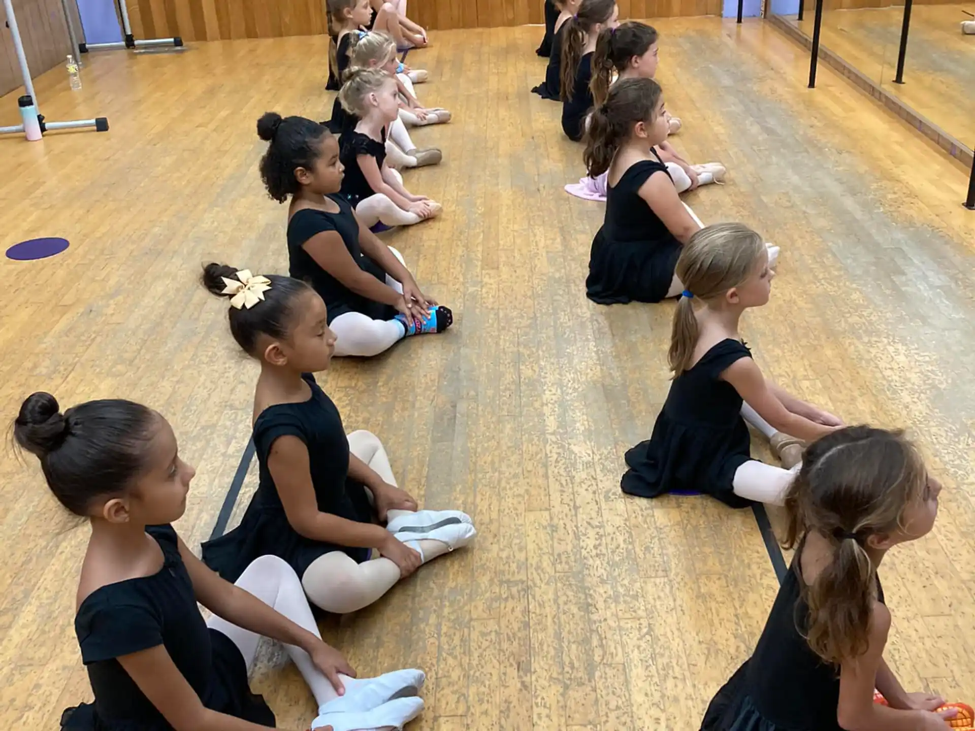 a group of girls kneeling on the floor