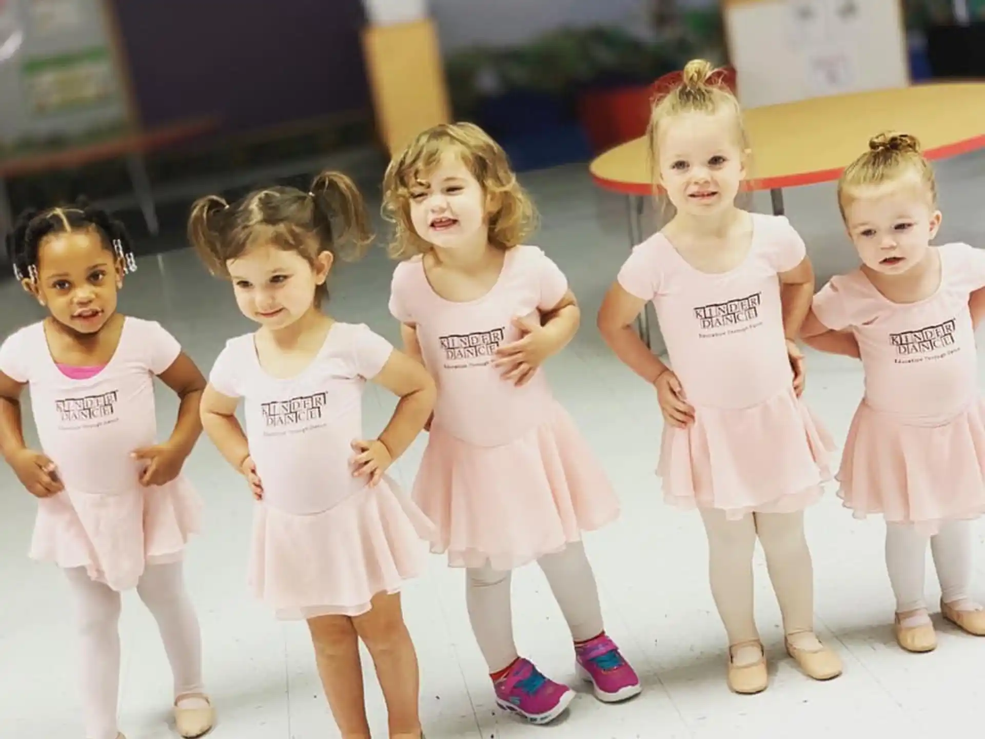a group of girls in white dresses