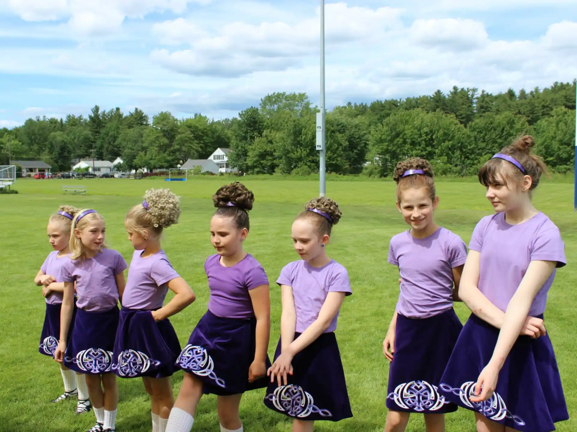 a group of girls in purple uniforms