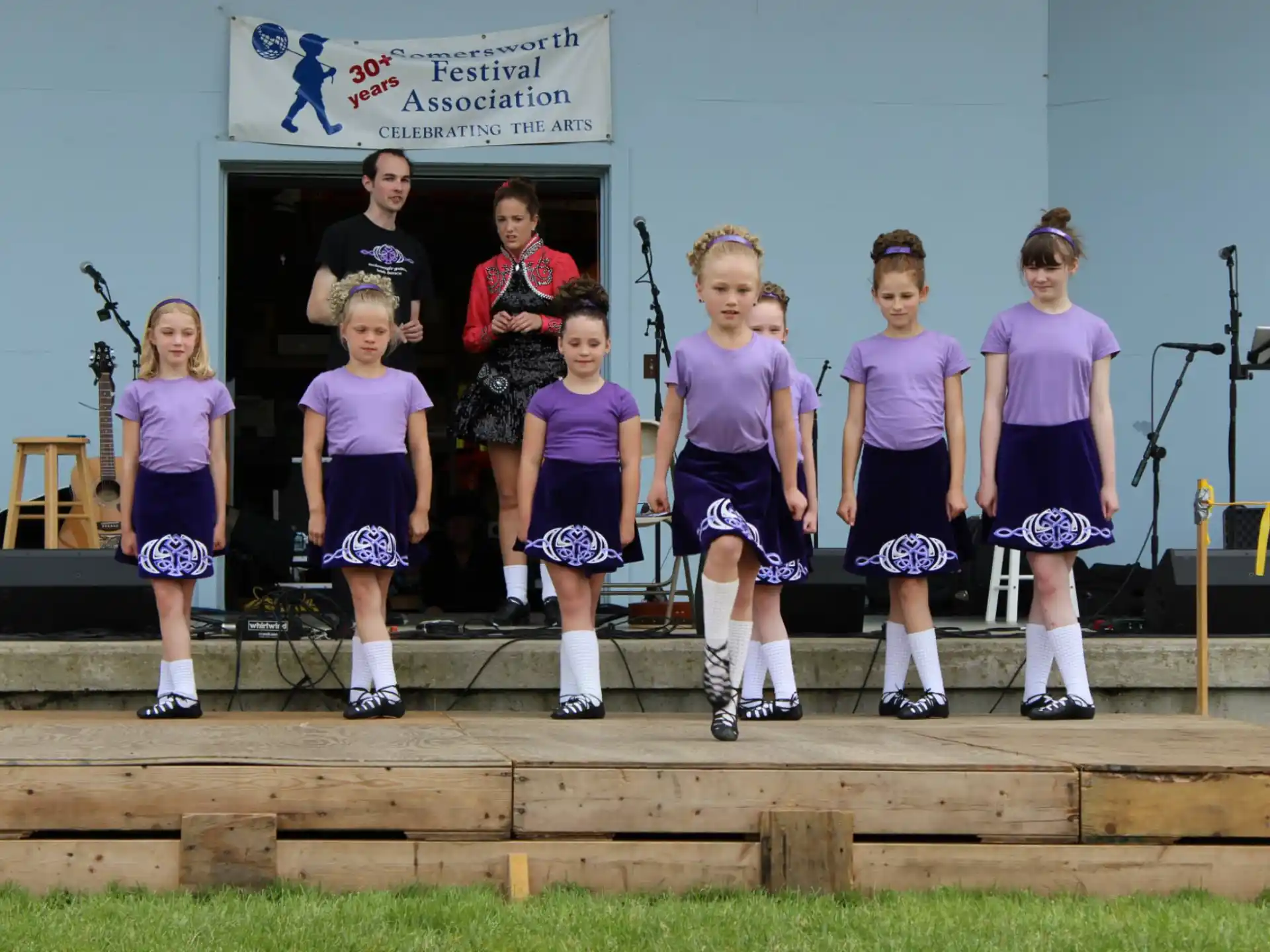 a group of girls in purple uniforms