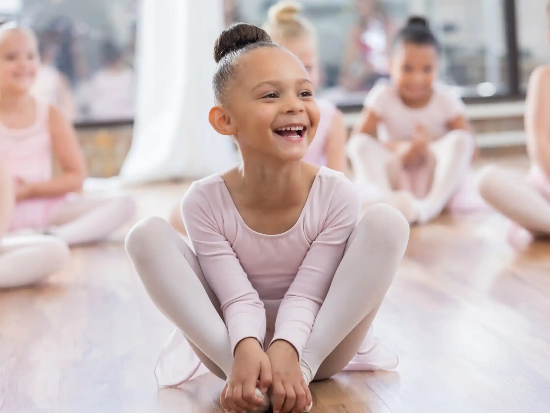 a young girl sitting on the floor
