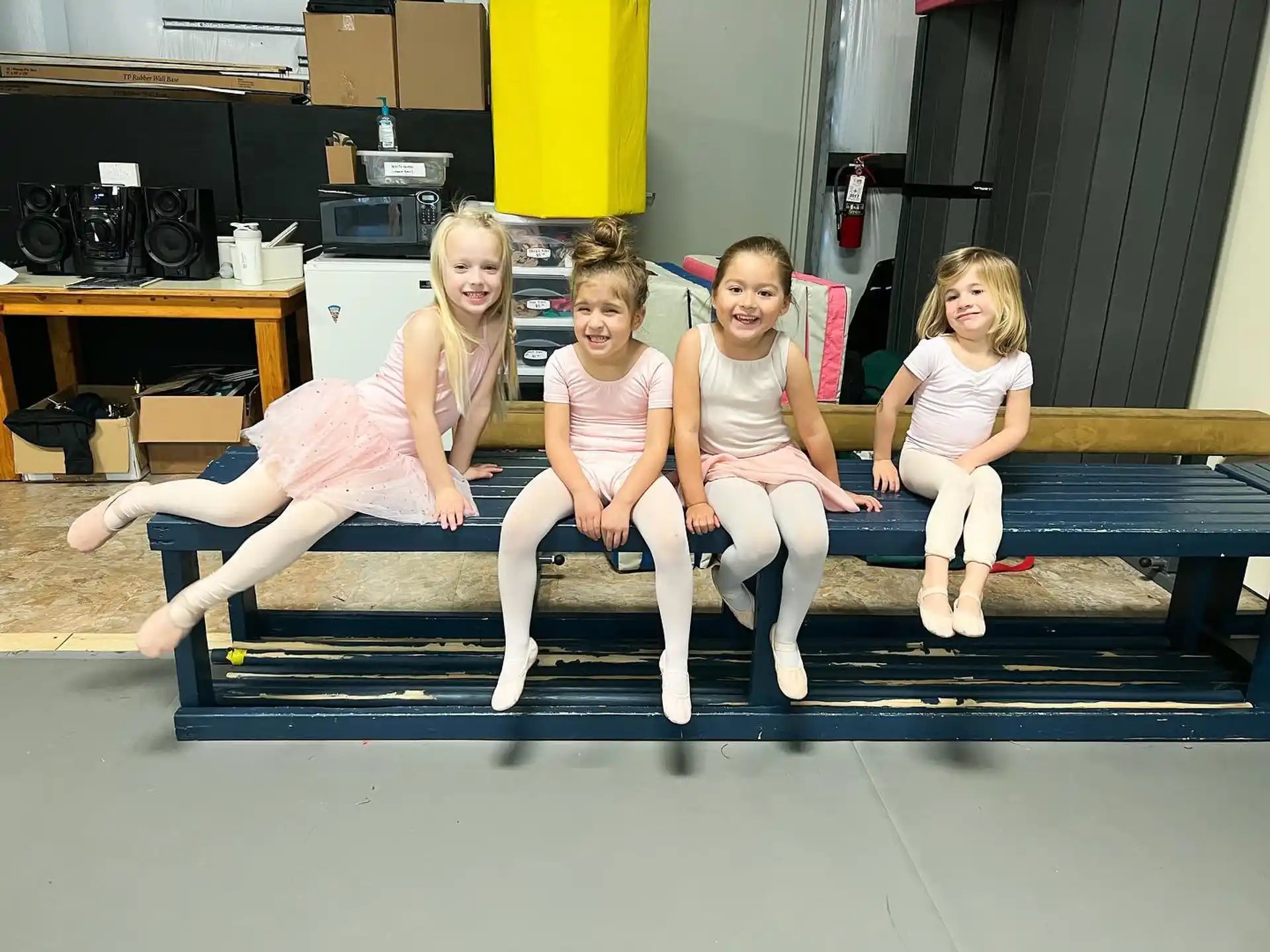 a group of girls sitting on a bench