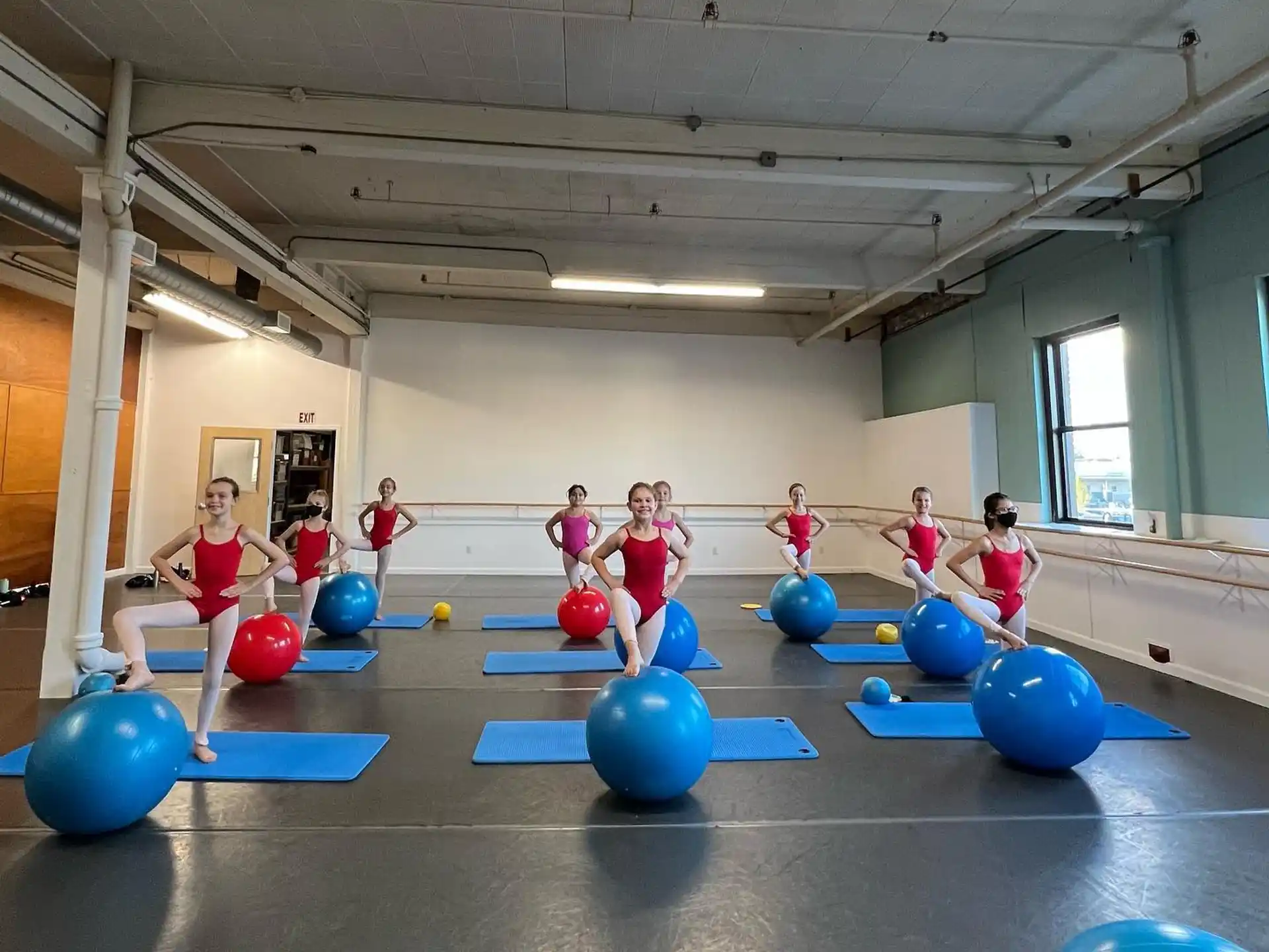 a group of children playing on a blue ball court