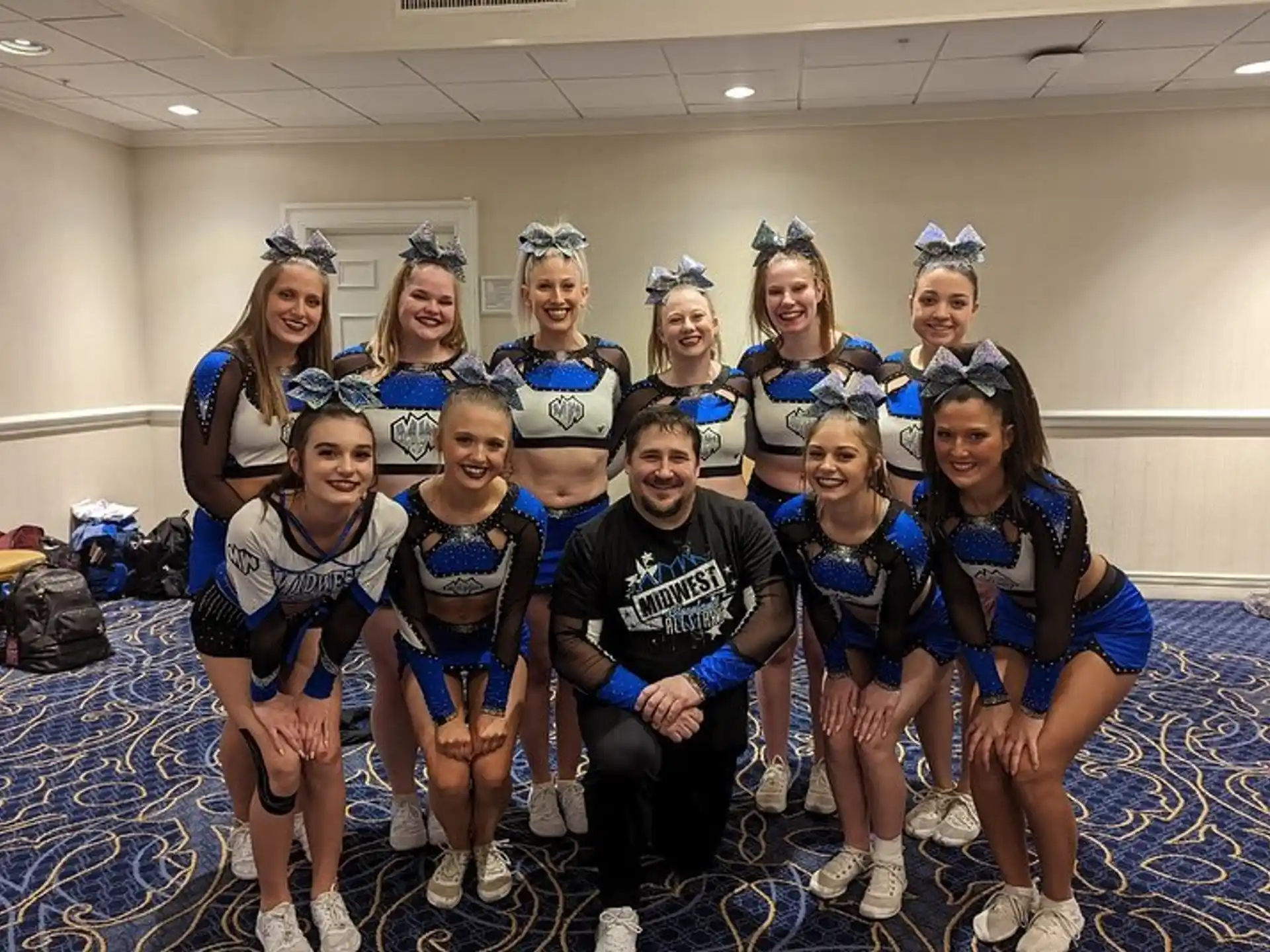 a group of people wearing cheerleaders posing for a photo