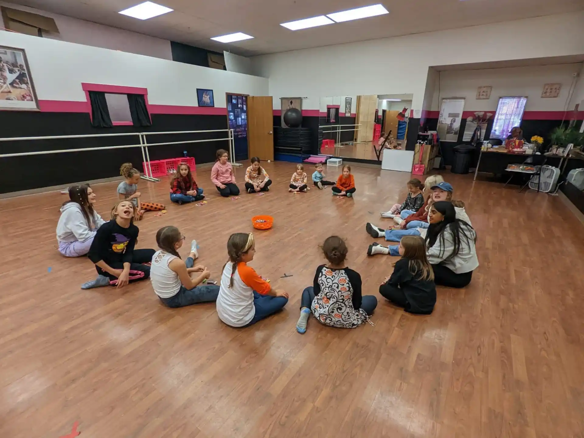 a group of children sitting on the floor in a room