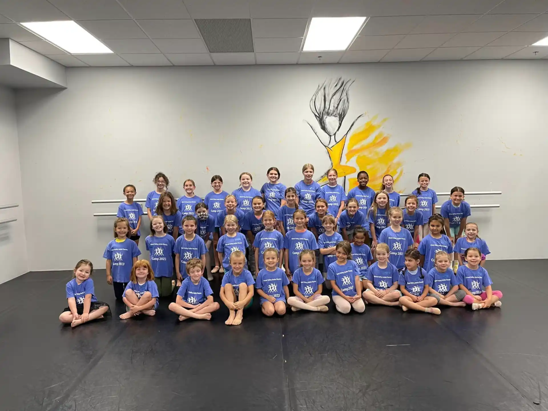 a group of children in blue shirts