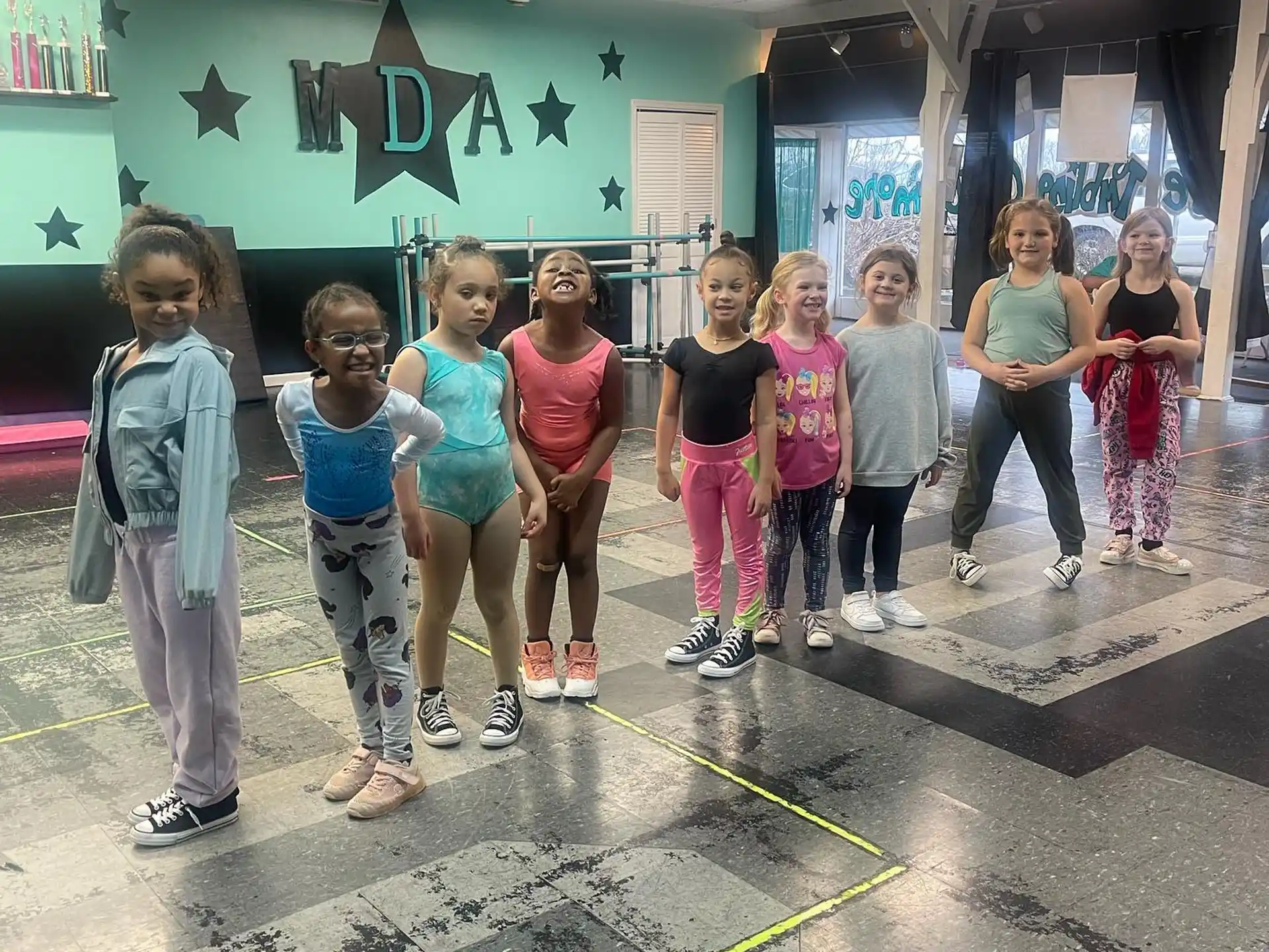 a group of children standing in a gym