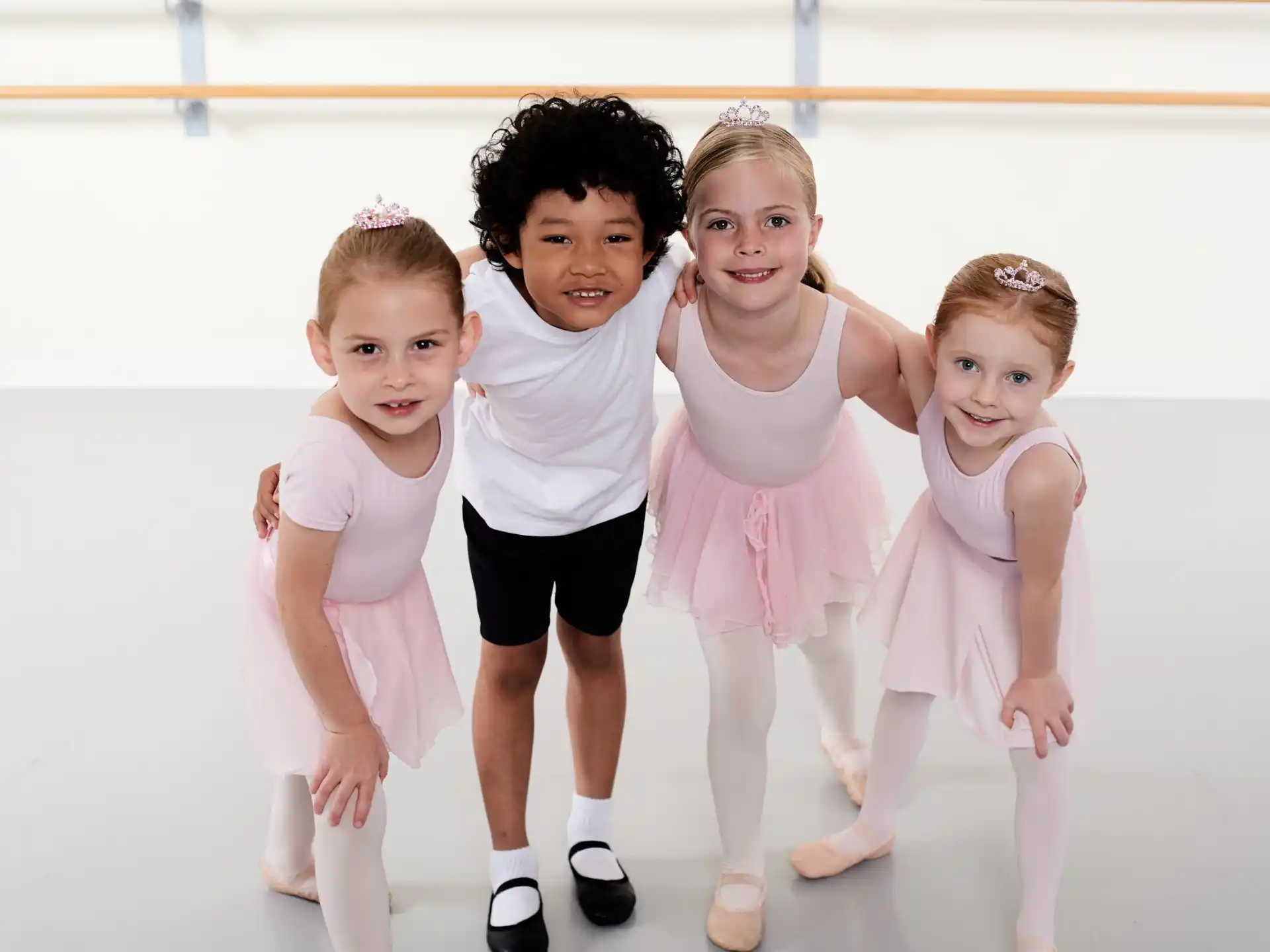 a group of children in white dresses