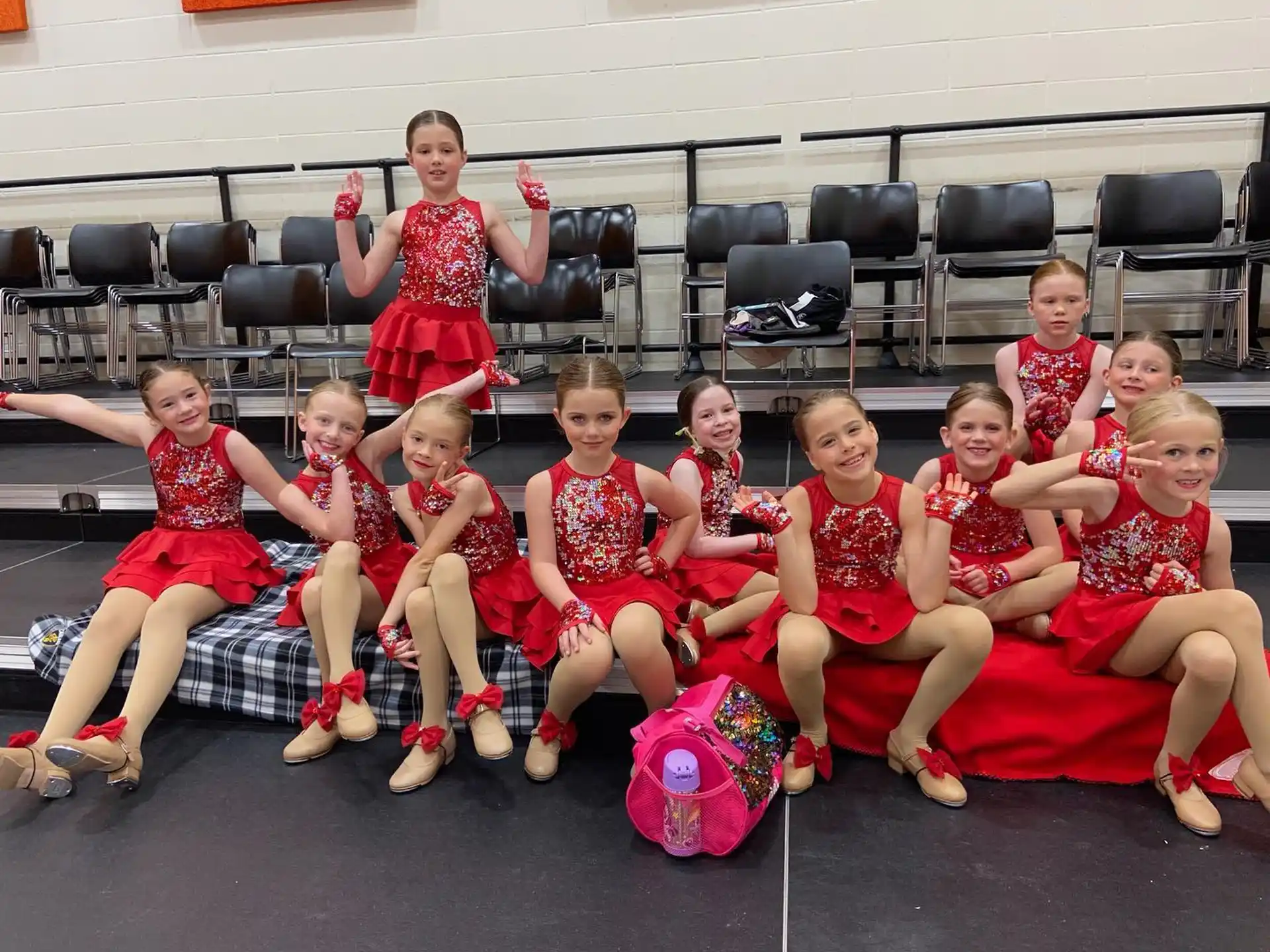 a group of children in red uniforms