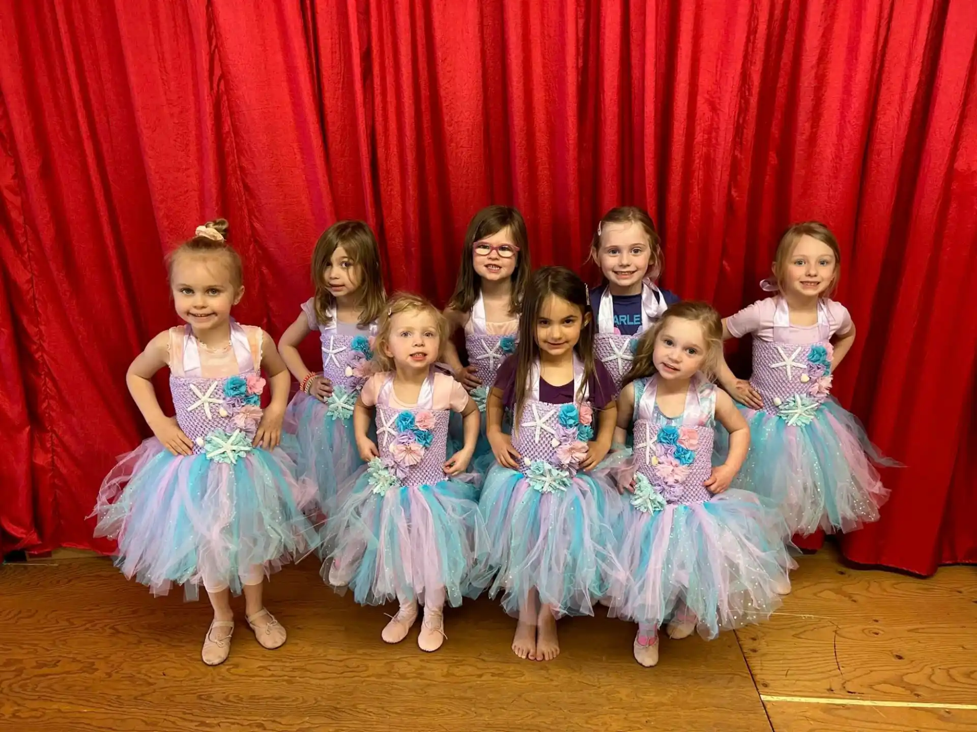 a group of girls in dresses