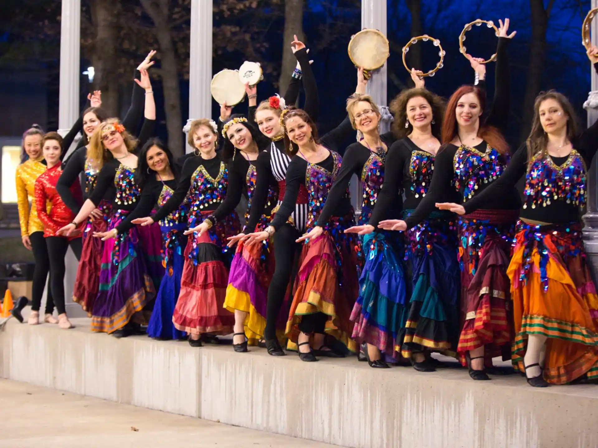 a group of women in colorful dresses