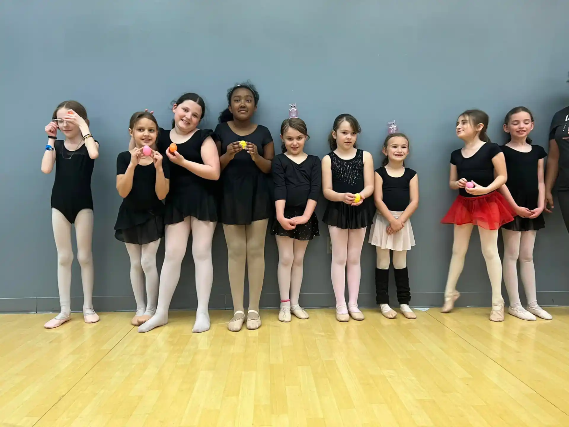 a group of girls in black dresses