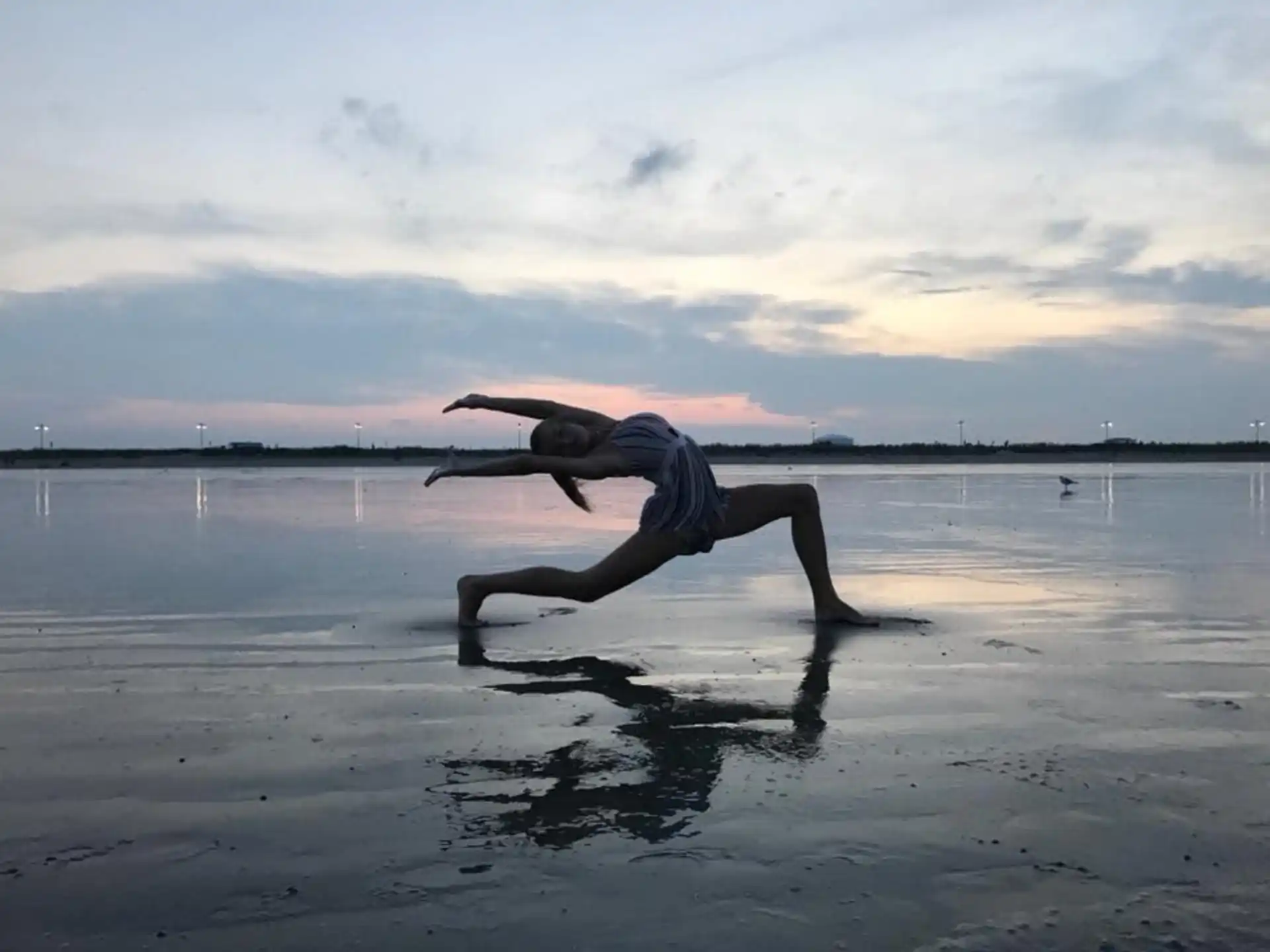 a person doing a handstand on a beach