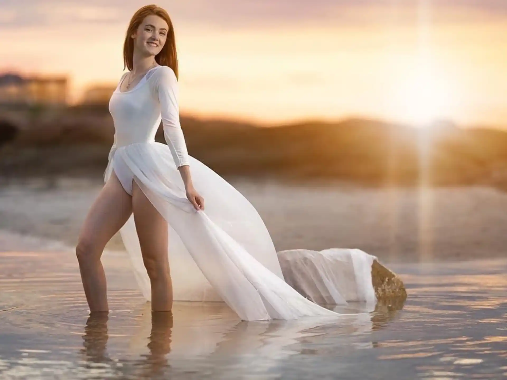 a person in a white dress on a beach