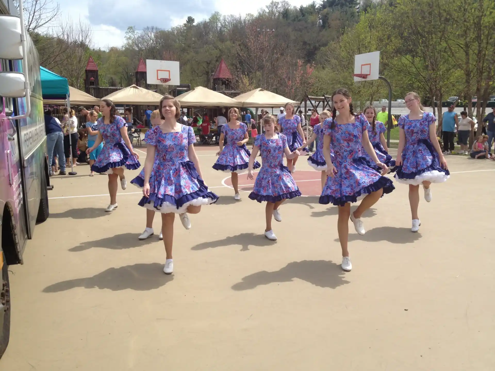 a group of women in dresses dancing
