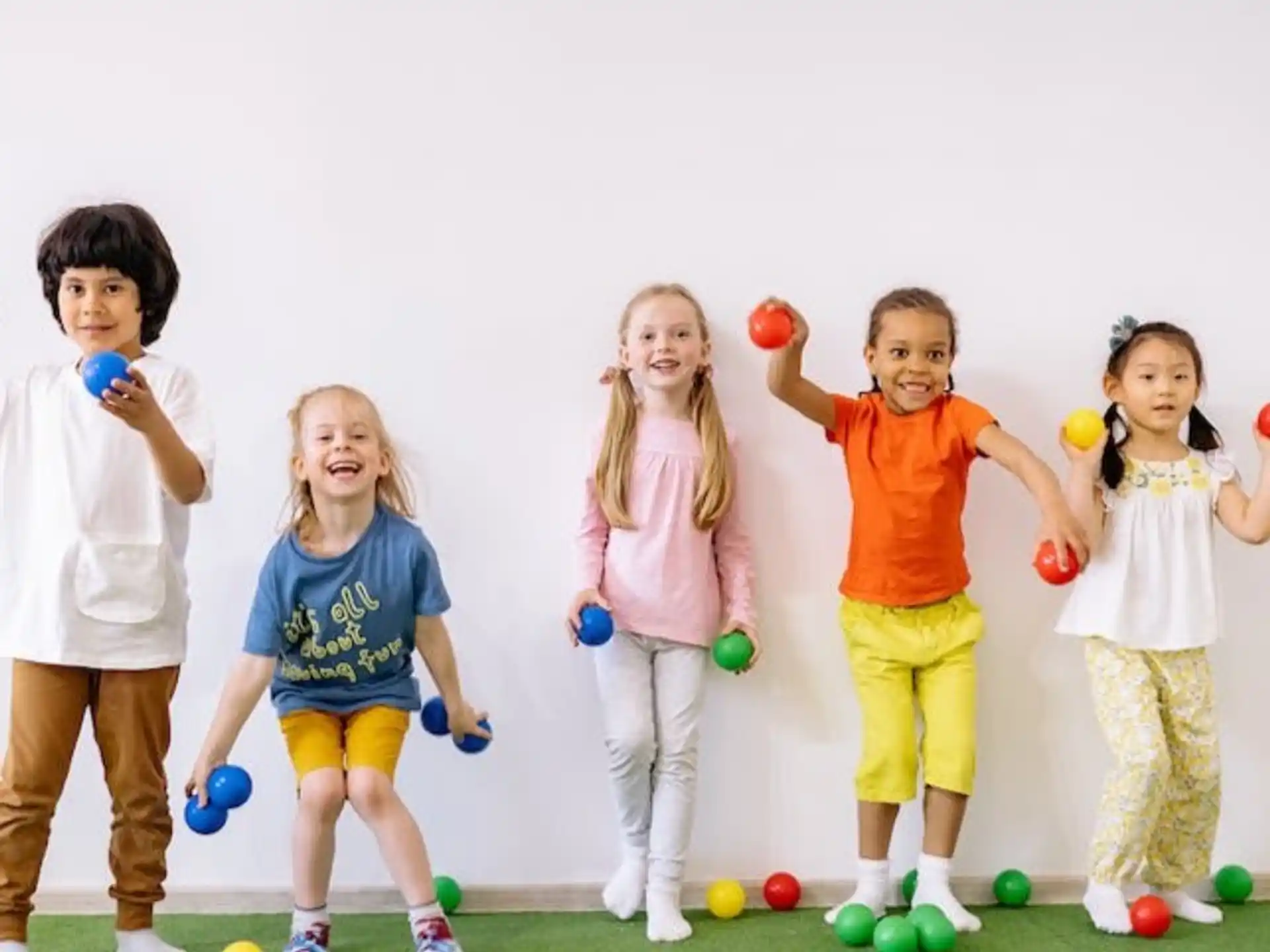a group of children holding balls