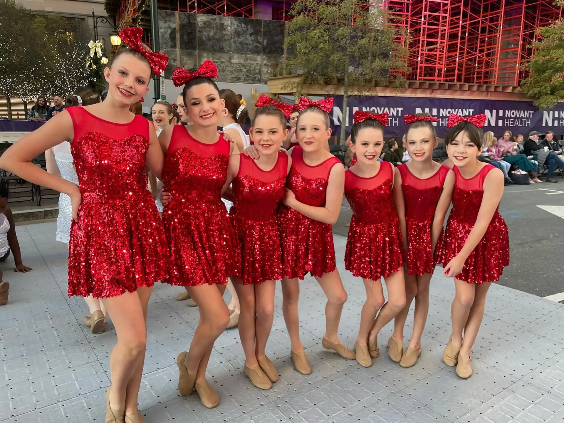 a group of women in red dresses