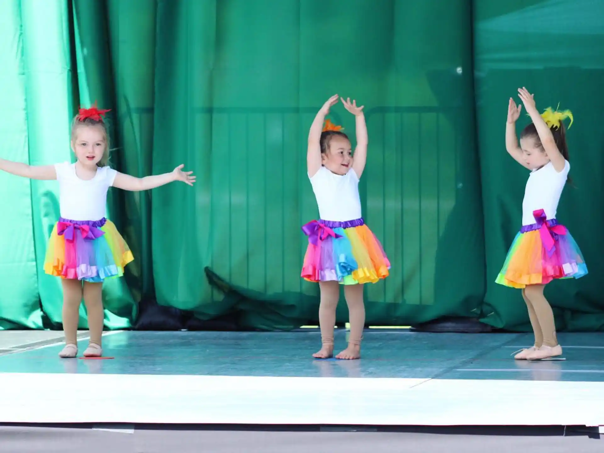a group of girls dancing on a stage