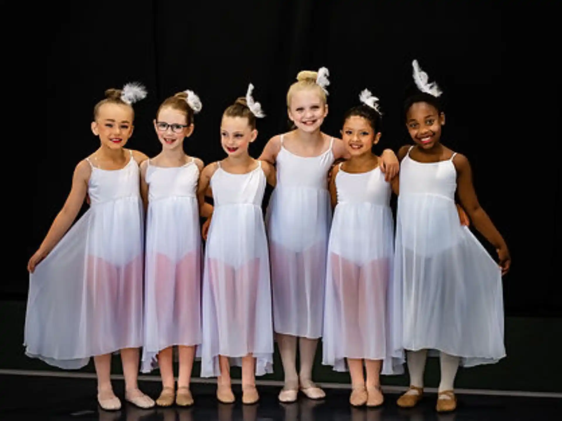 a group of girls in dresses