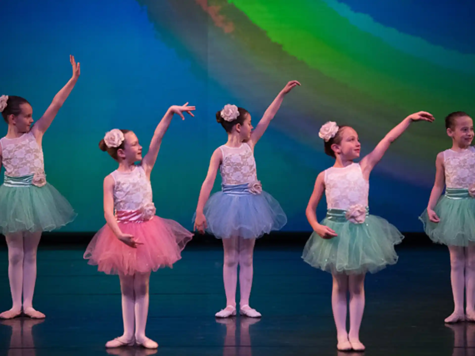 a group of girls in dresses dancing