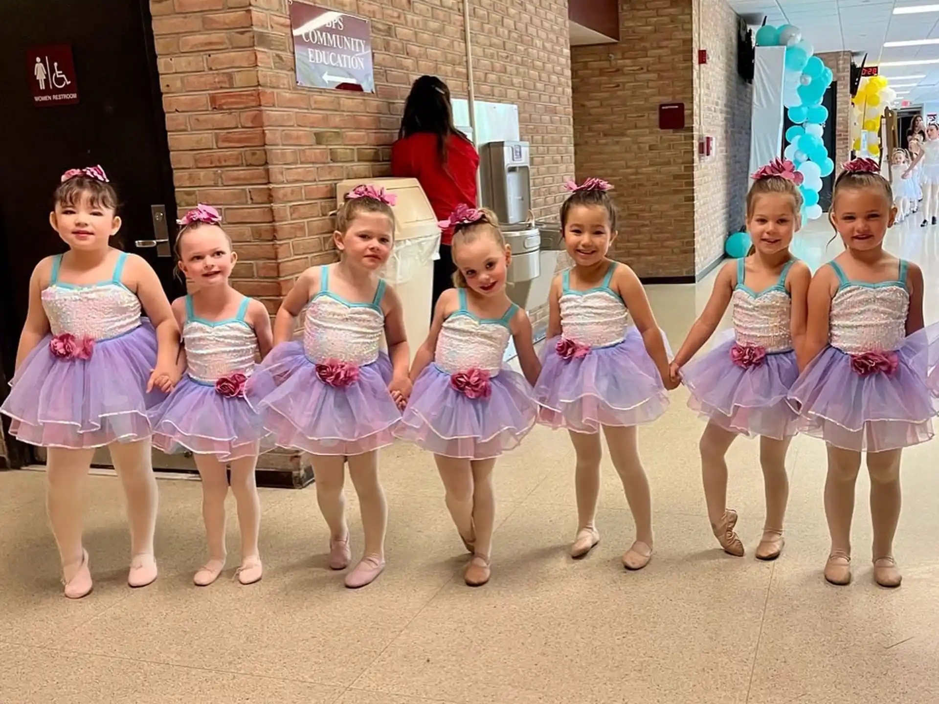 a group of girls in dresses