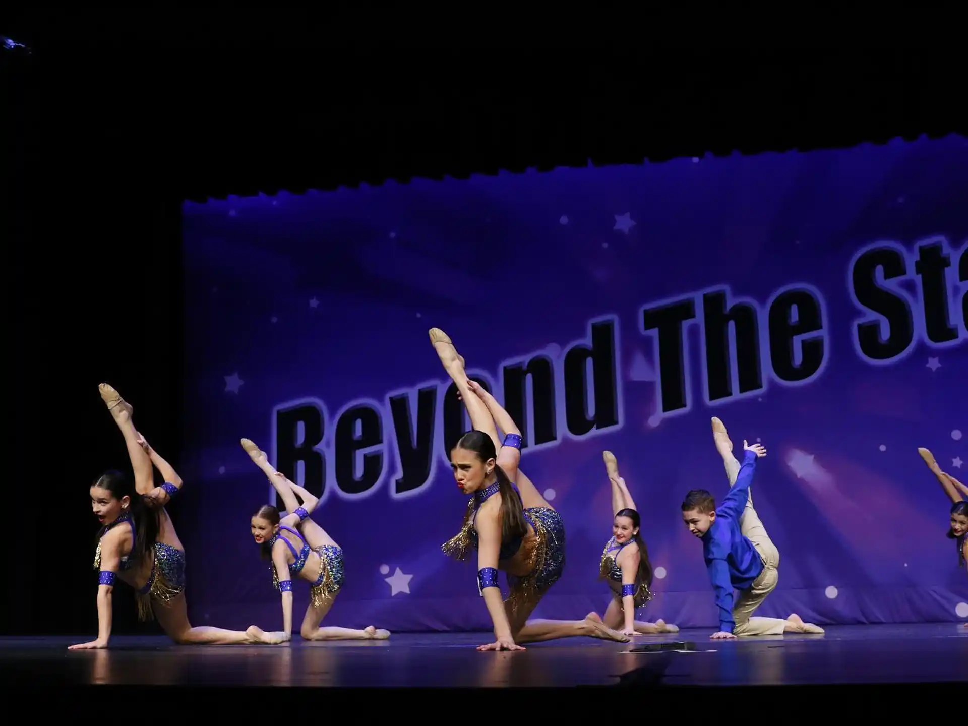a group of people dancing on a stage