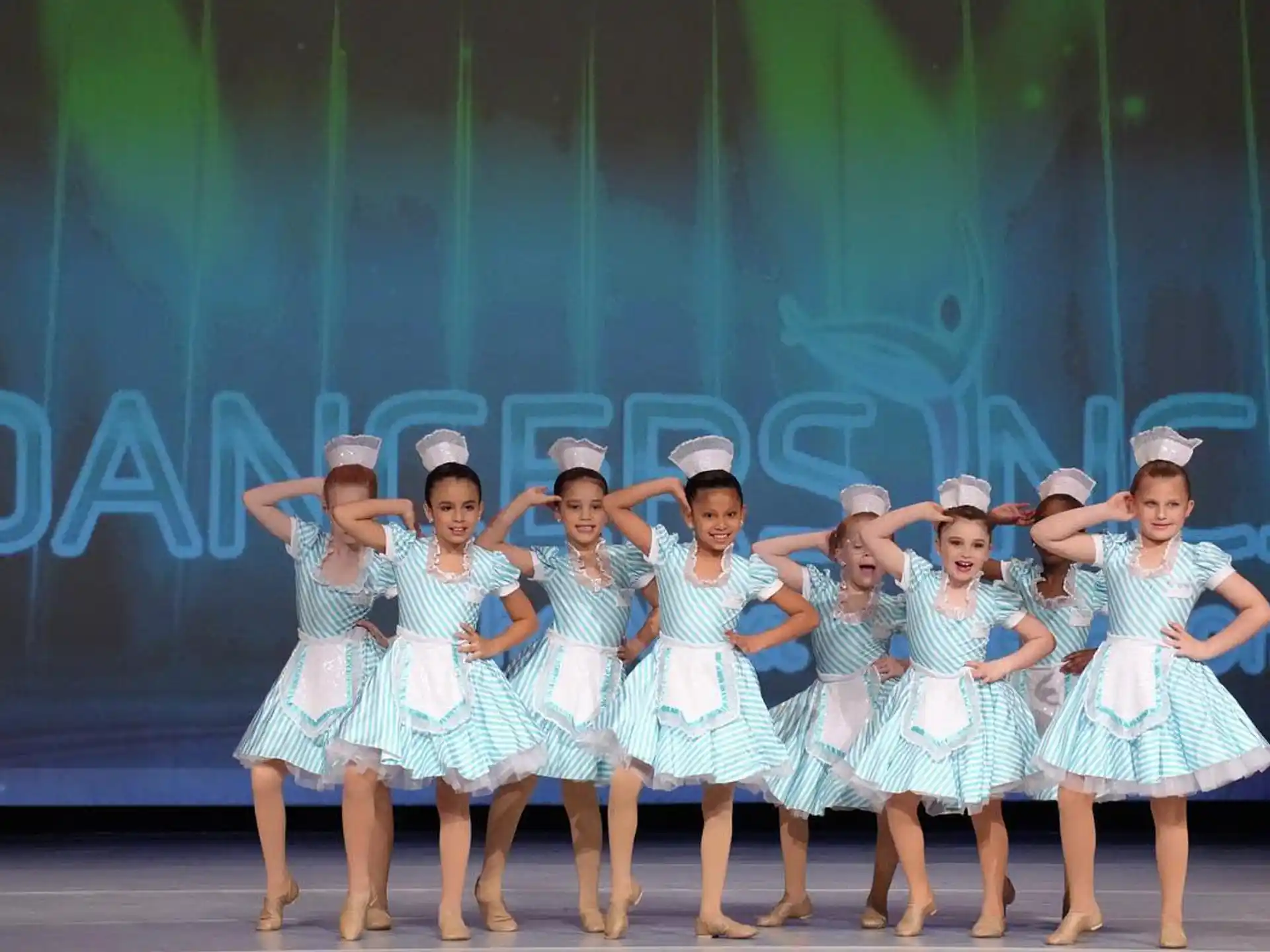 a group of girls in blue dresses