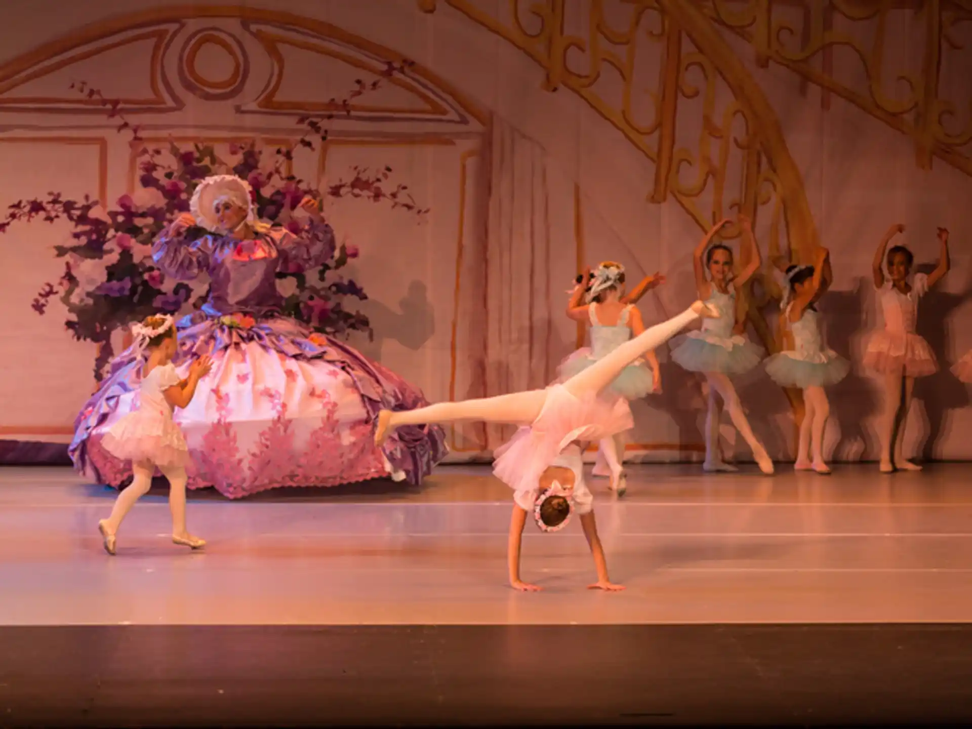 a group of dancers performing on a stage