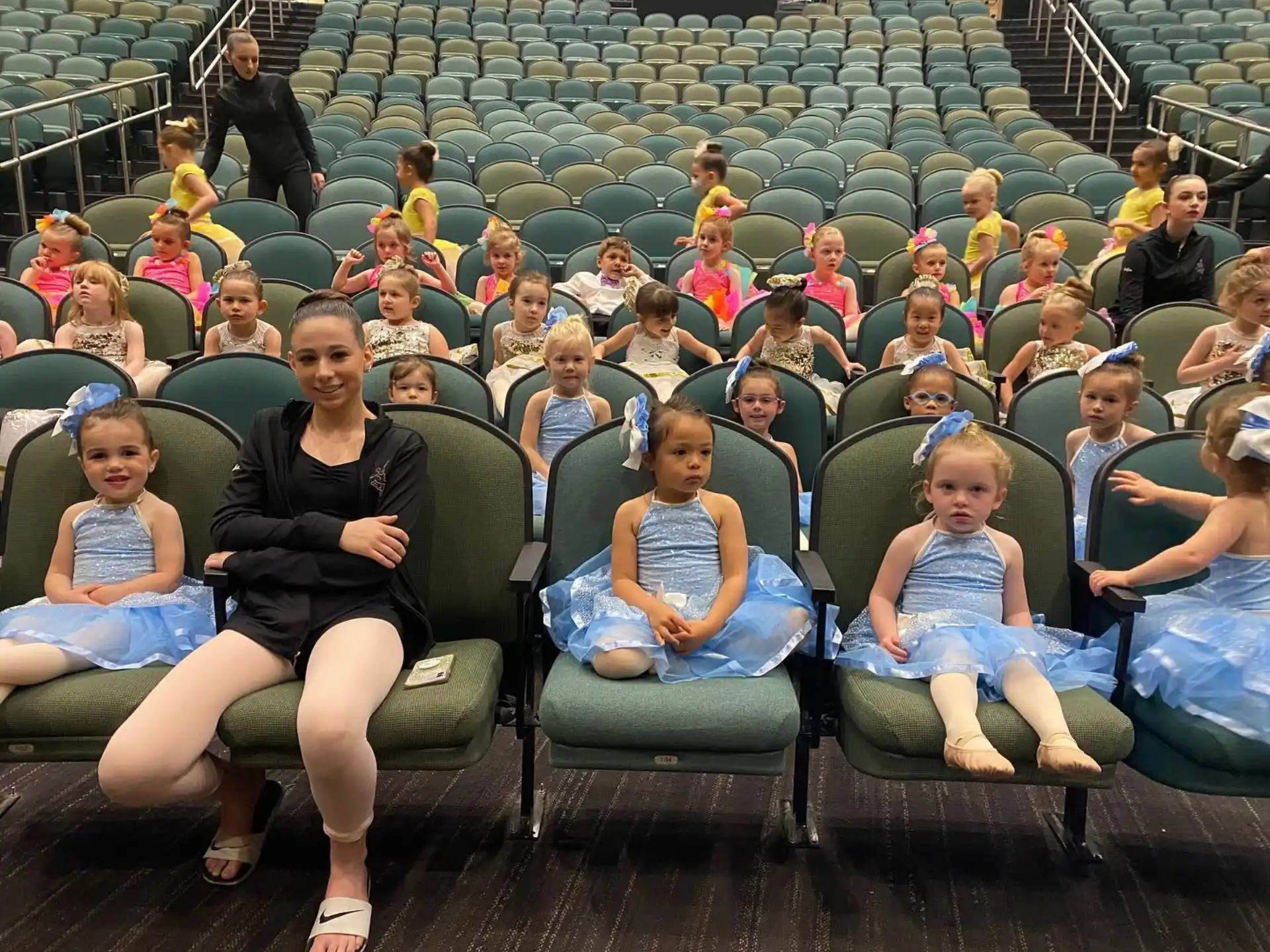 a group of children sitting in chairs