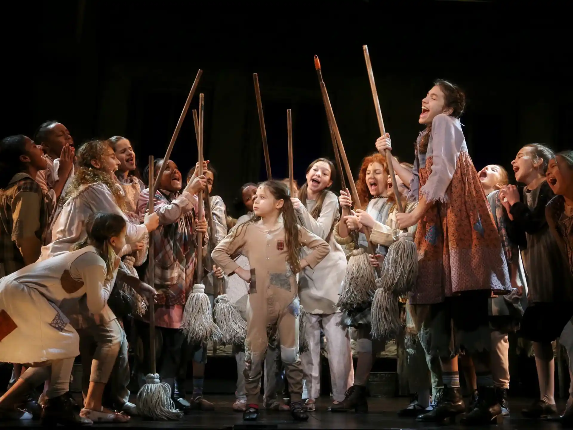 a group of people holding sticks