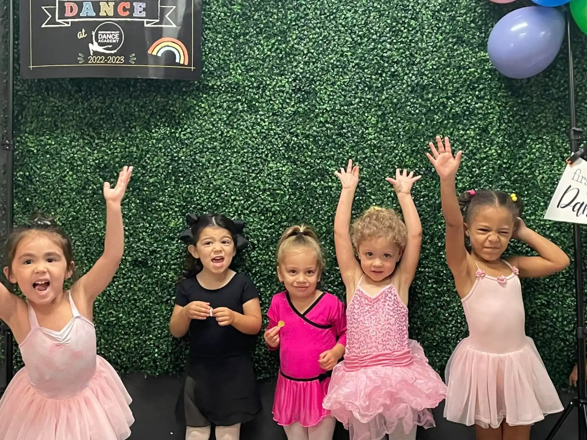 a group of girls holding balloons