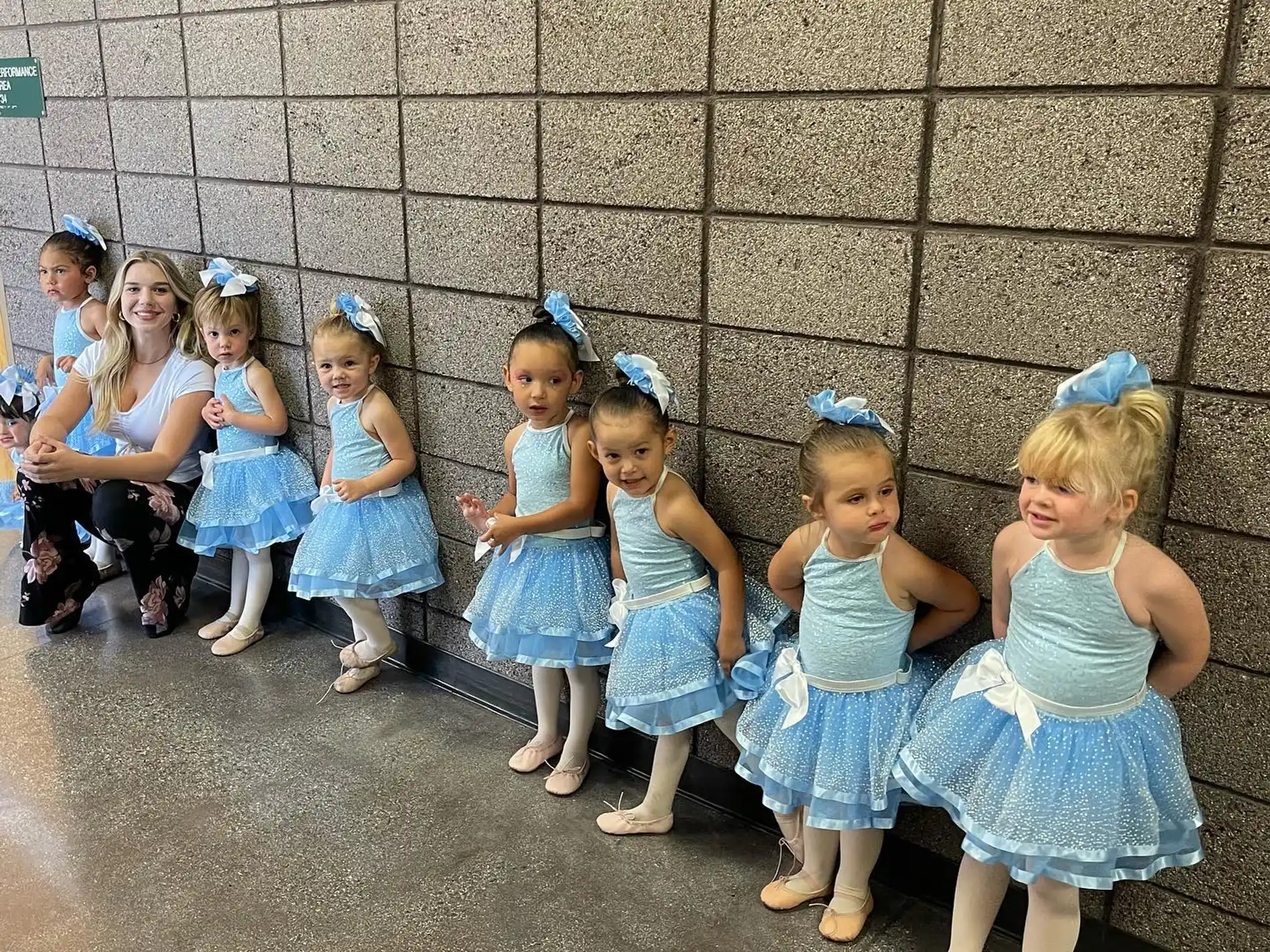 a group of girls in blue dresses