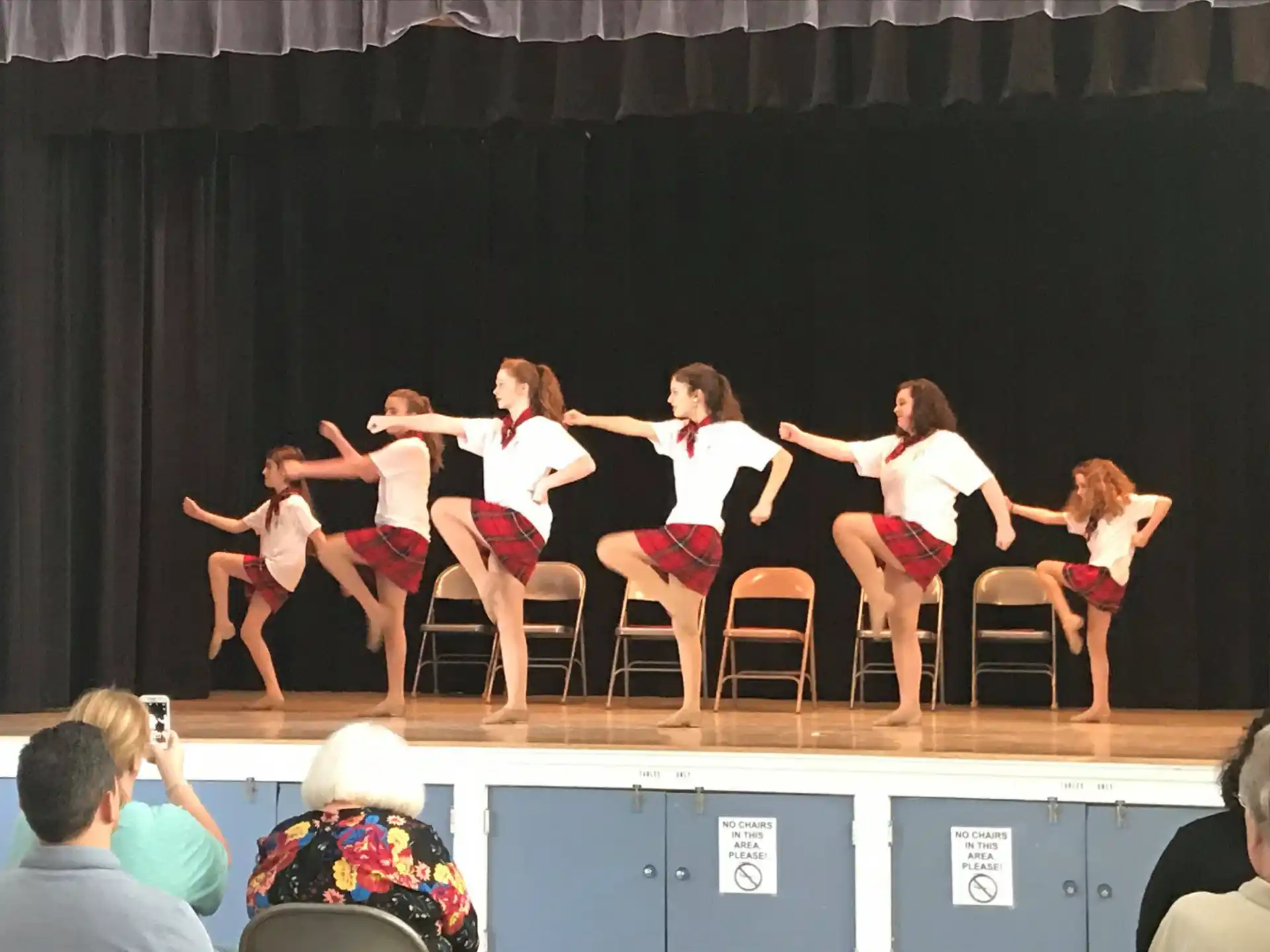 a group of women performing on a stage