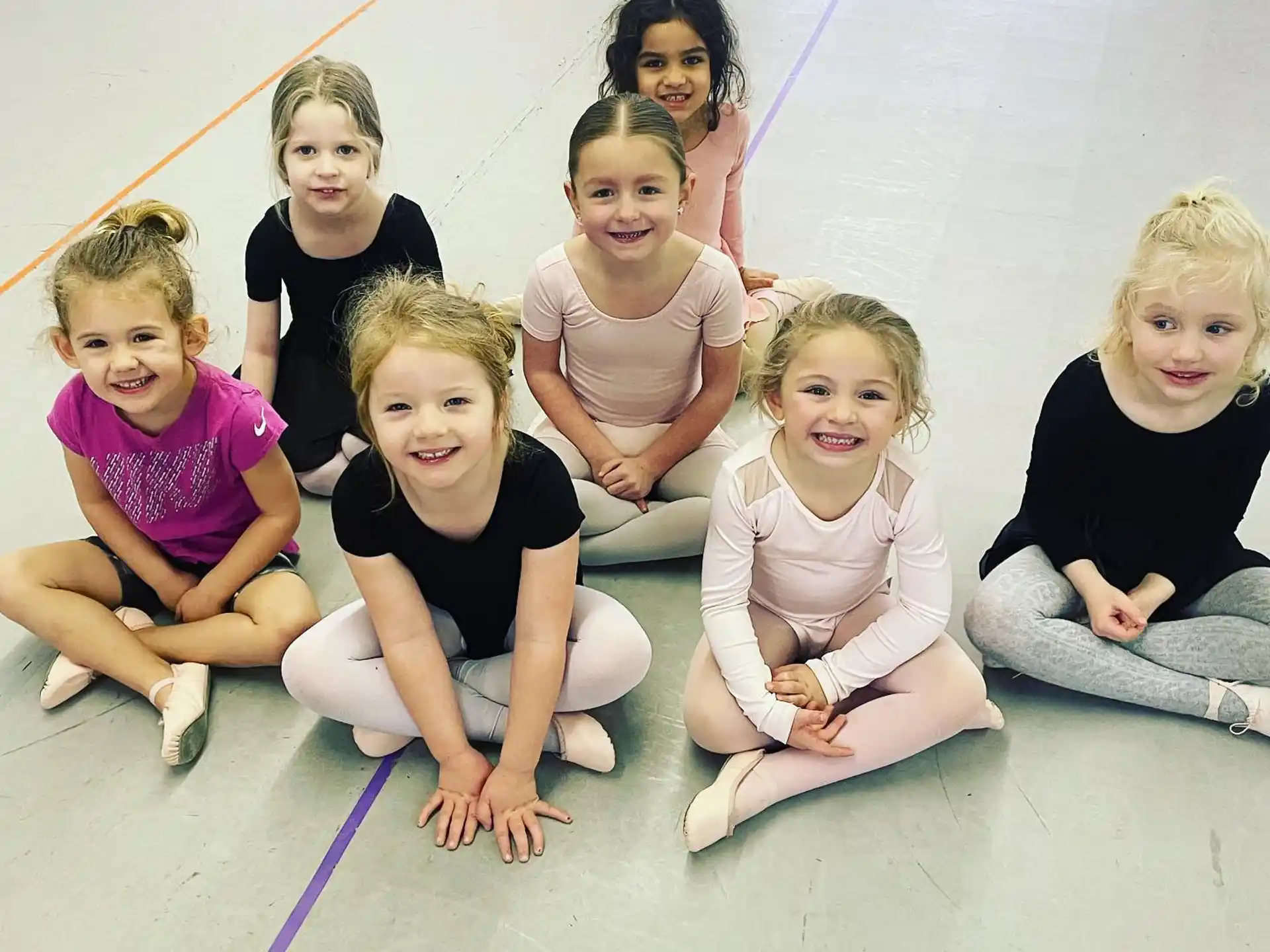 a group of children sitting on the ground