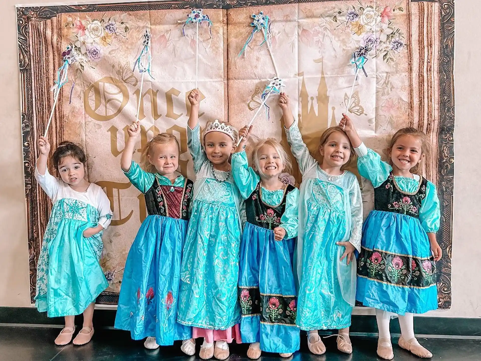 a group of girls in dresses
