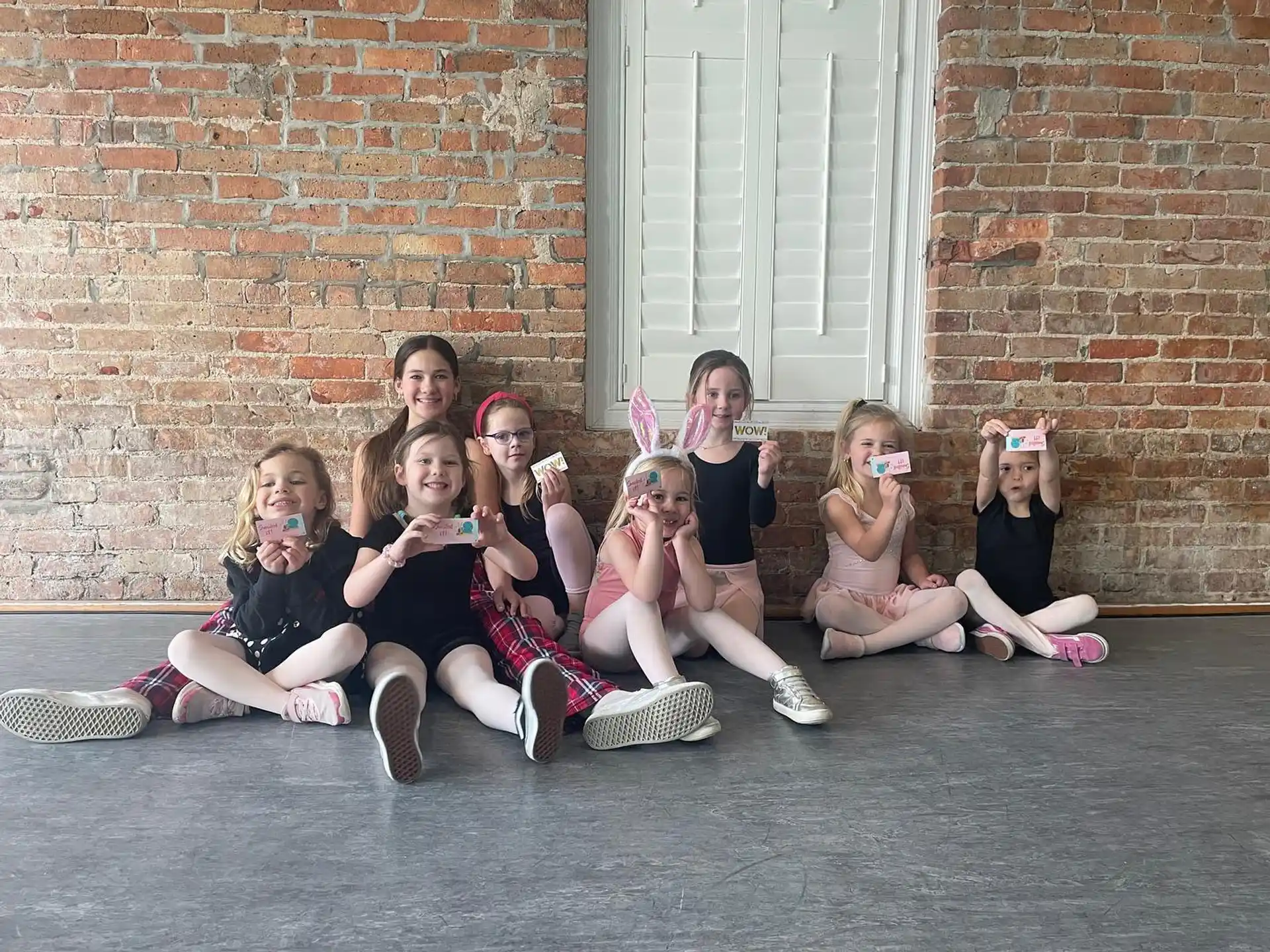 a group of girls sitting on the ground