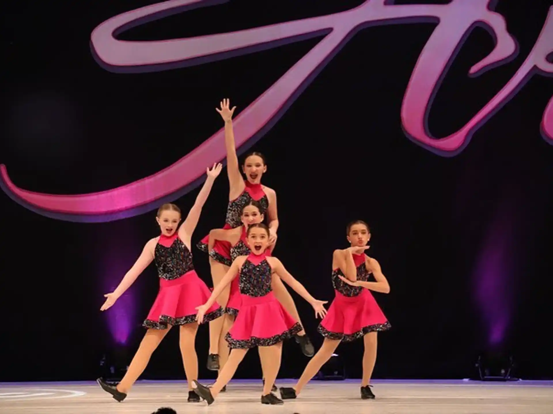 a group of women dancing on a stage