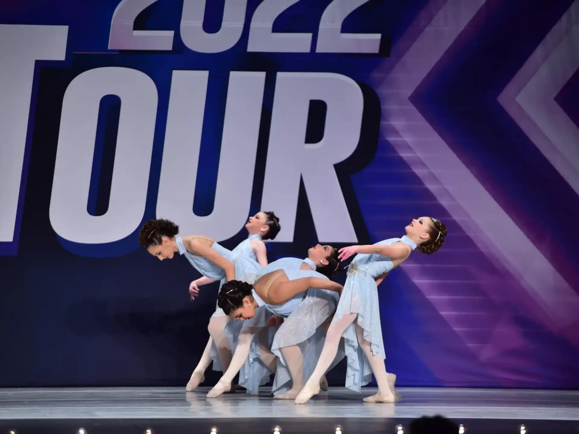 a group of people dancing on a stage