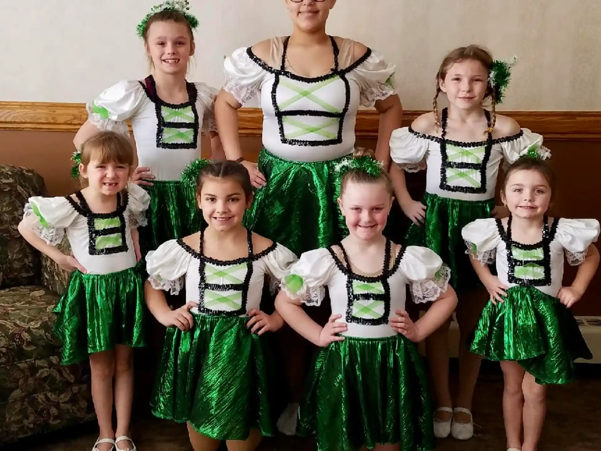 a group of girls in green dresses