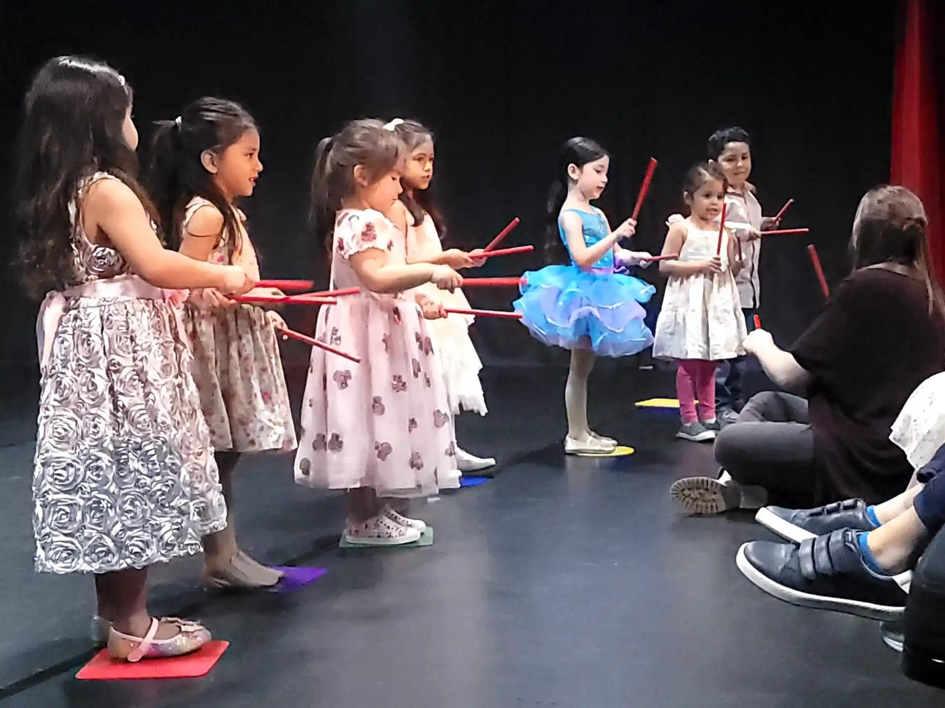 a group of children performing on stage