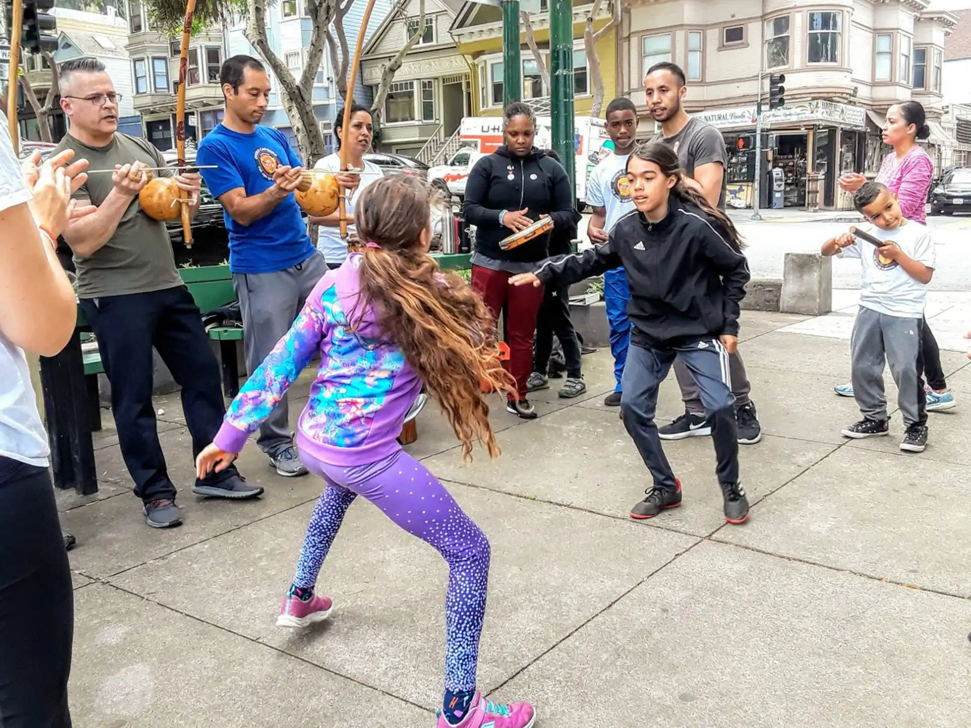 a girl dancing in front of a crowd of people
