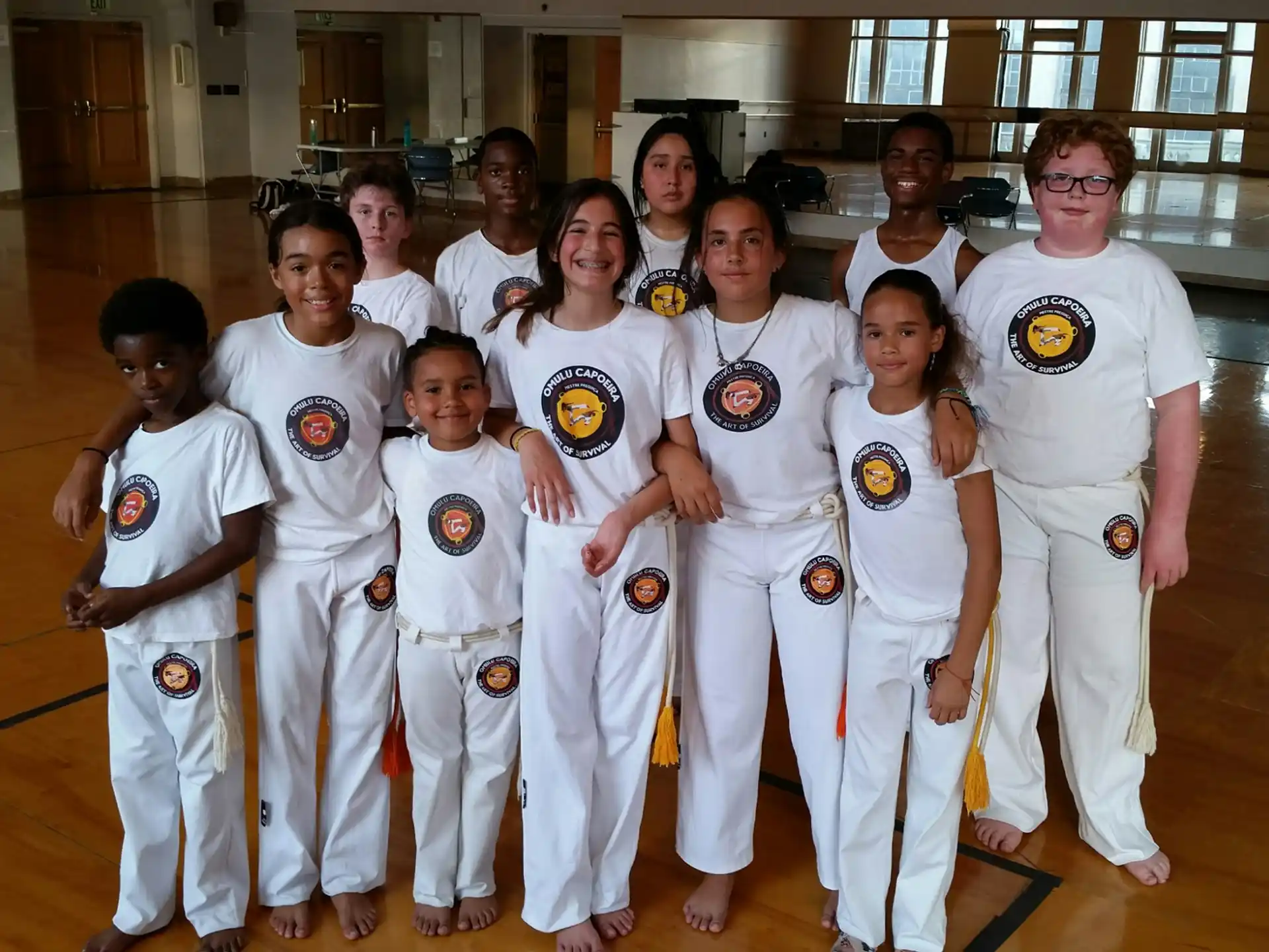 a group of people in white karate uniforms