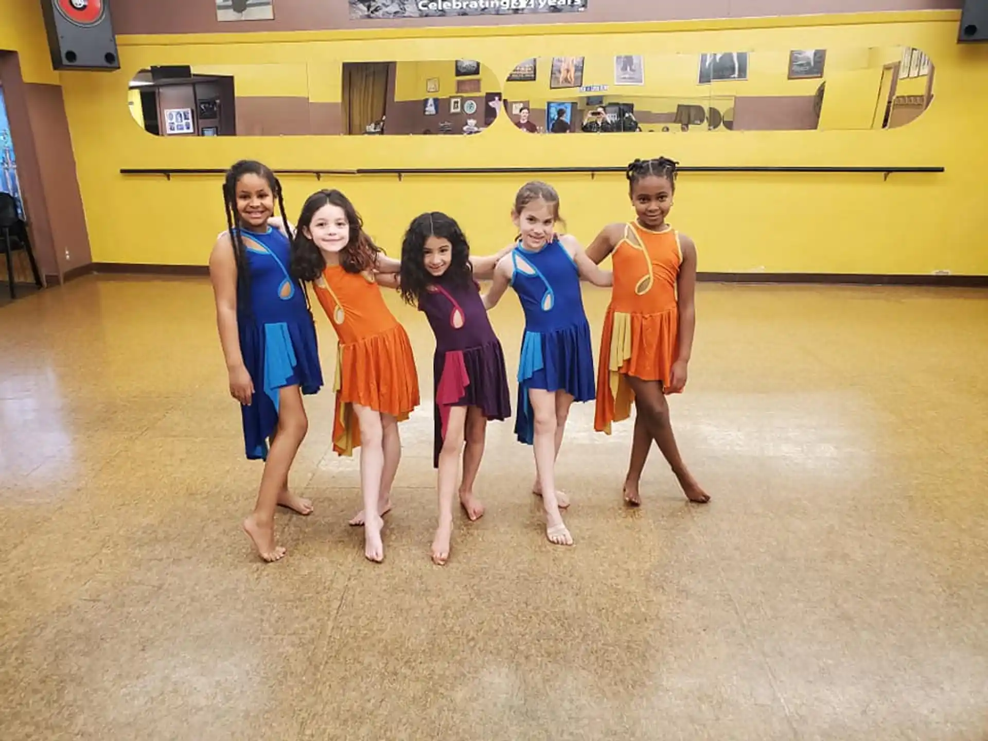 a group of girls in dresses